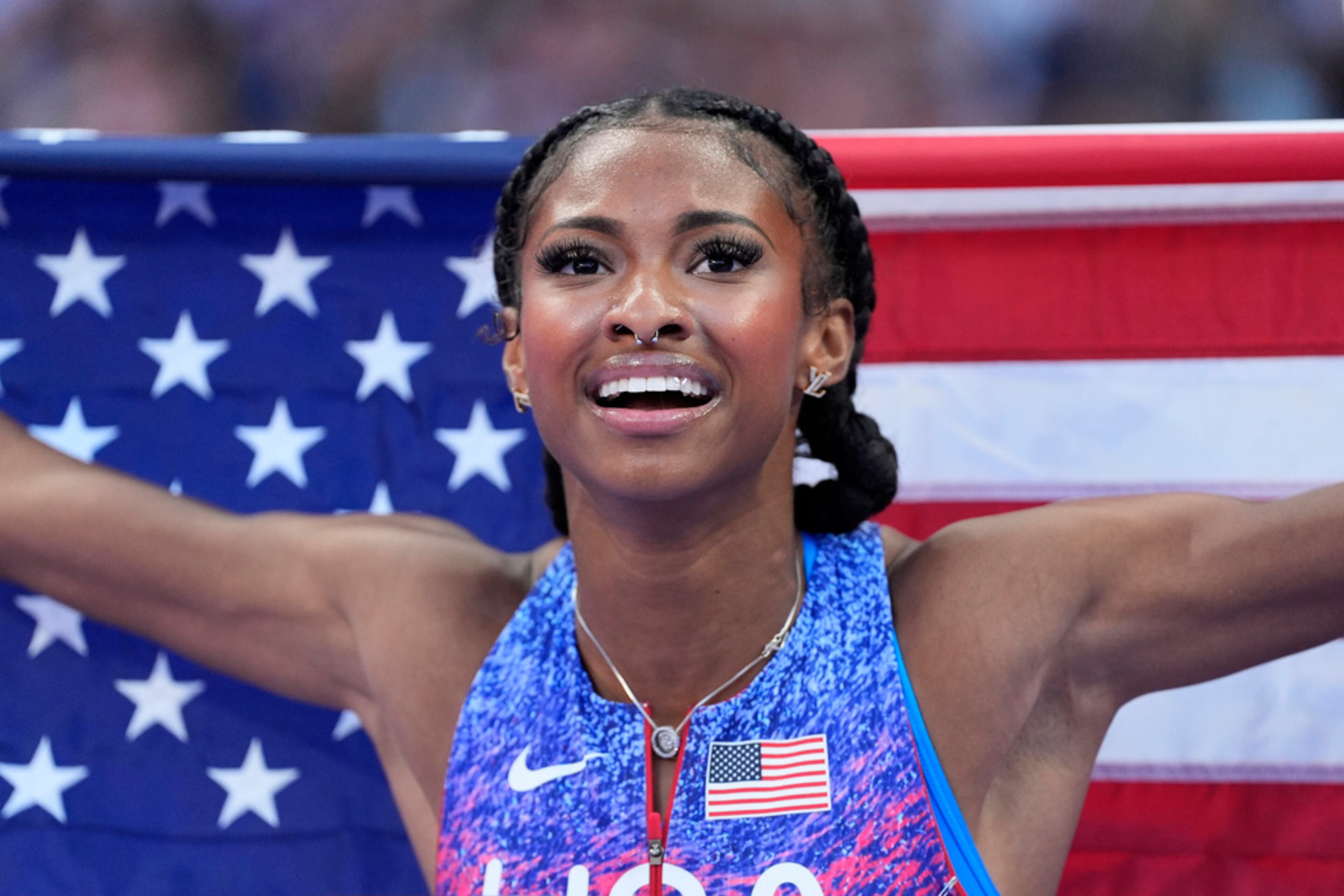 Masai Russell, of the United States, celebrates winning the women's 100-meter hurdles final at the 2024 Summer Olympics, Saturday, Aug. 10, 2024, in Saint-Denis, France. (AP Photo/Matthias Schrader)