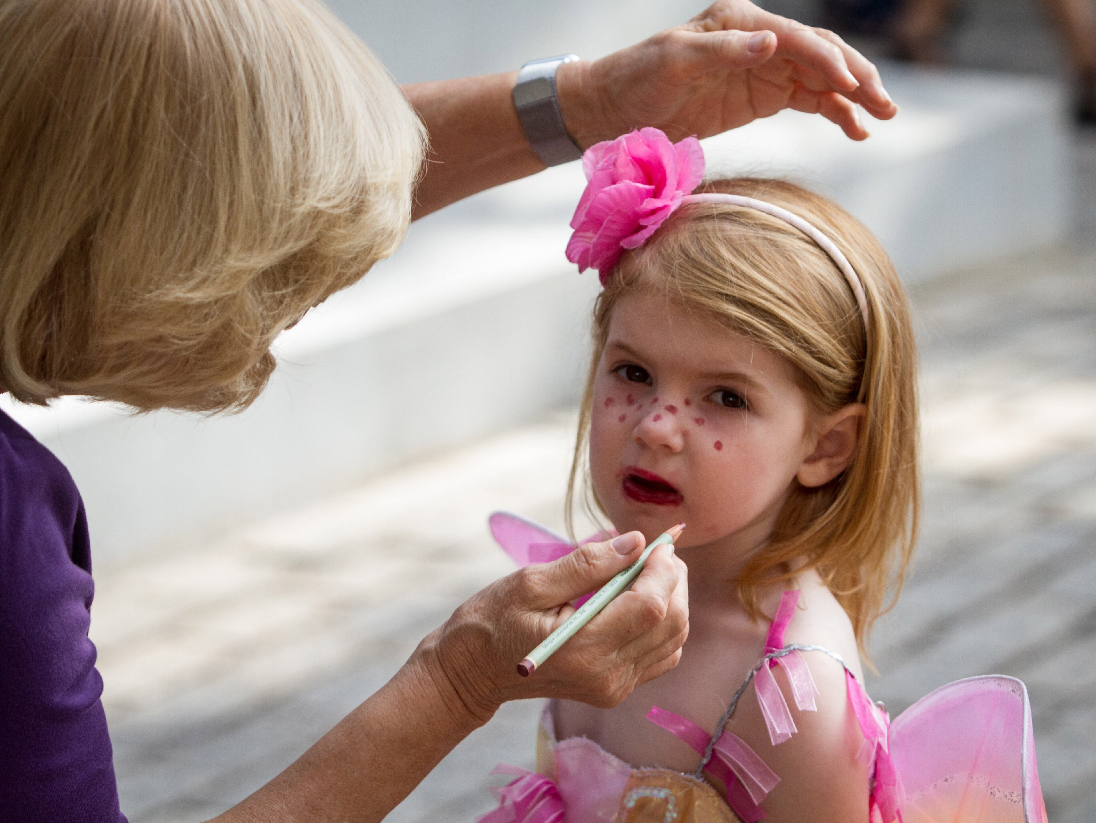 Louise Gentry puts the final touches on her granddaughter Carsen Lucas' costume before the children's parade at the AJC Decatur Book Festival Saturday, September 1, 2018. The festival kicked off Friday night and continues Sunday. (Photo: STEVE SCHAEFER / SPECIAL TO THE AJC)