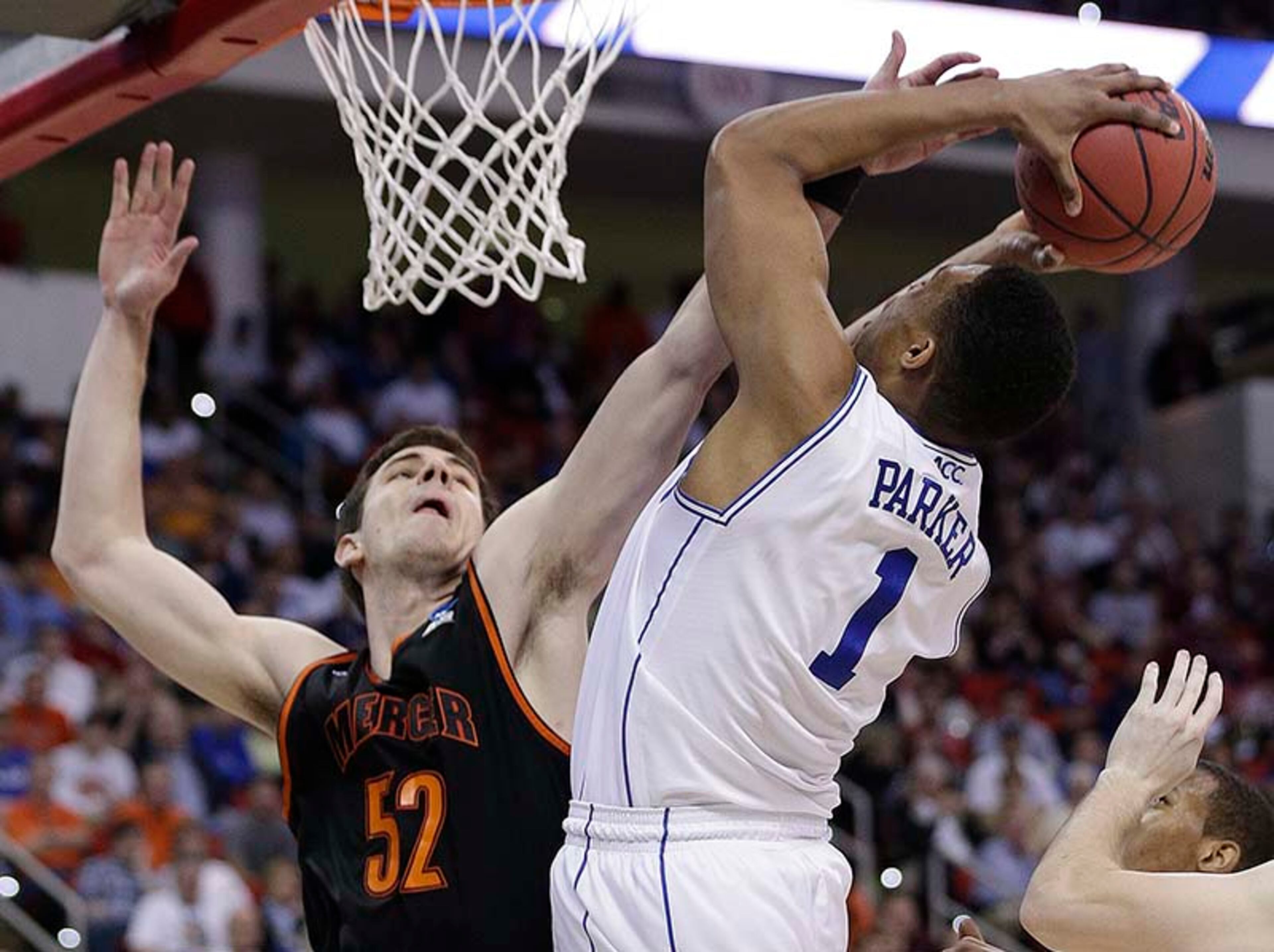 Duke forward Jabari Parker (1) shoots over Mercer forward Daniel Coursey (52) during the second half of an NCAA college basketball second-round game, Friday, March 21, 2014, in Raleigh, N.C. Mercer upset Duke 78-71 in the second round of the NCAA Tournament. It's first tournament win in nearly three decades.