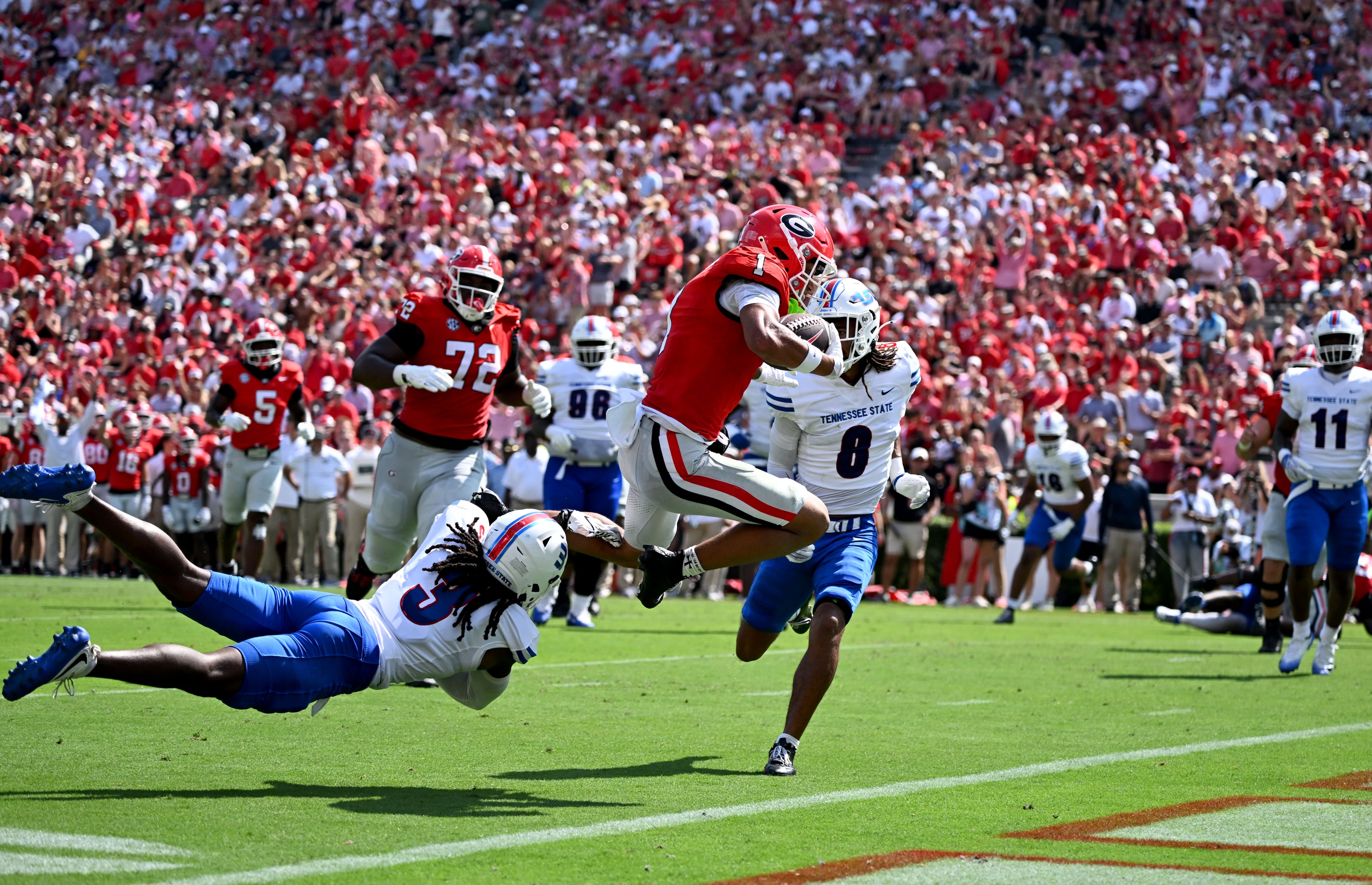Georgia wide receiver Talyn Taylor runs past Tennessee State defensive back Mikeece Jones for a touchdown during the first half in an NCAA football game at Sanford Stadium on Saturday, Sept. 5, 2026, in Athens, Ga. (Hyosub Shin/AJC)