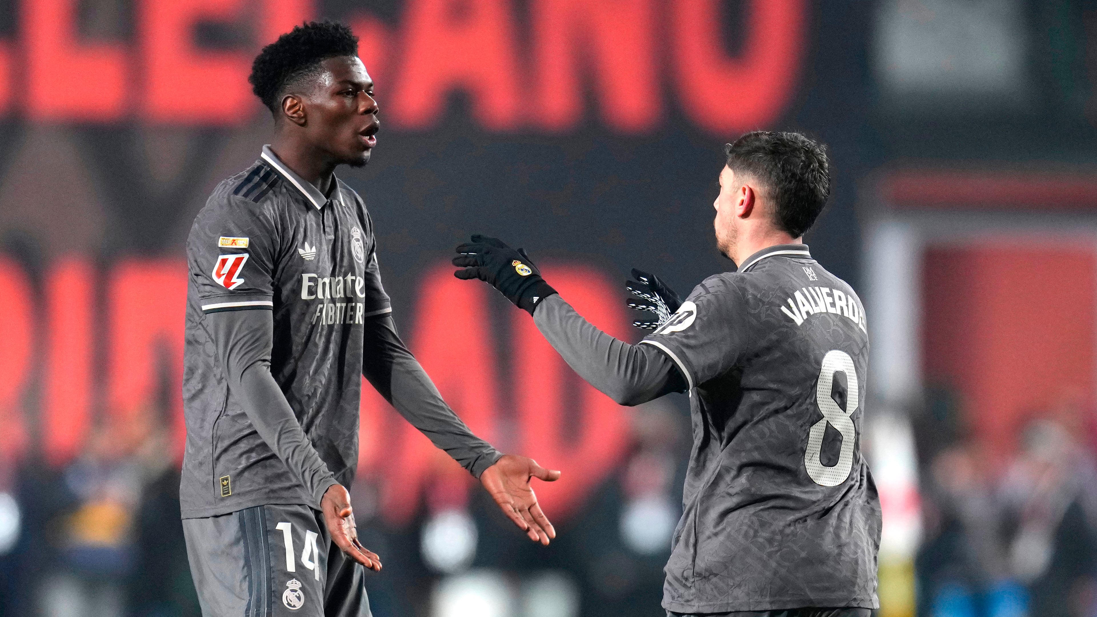 FILE - Real Madrid's Federico Valverde, right, celebrates with Aurelien Tchouameni after scoring his side's opening goal during the Spanish La Liga soccer match between Rayo Vallecano and Real Madrid at the Vallecas stadium in Madrid, Spain, Saturday, Dec. 14, 2024. (AP Photo/Manu Fernandez, File)