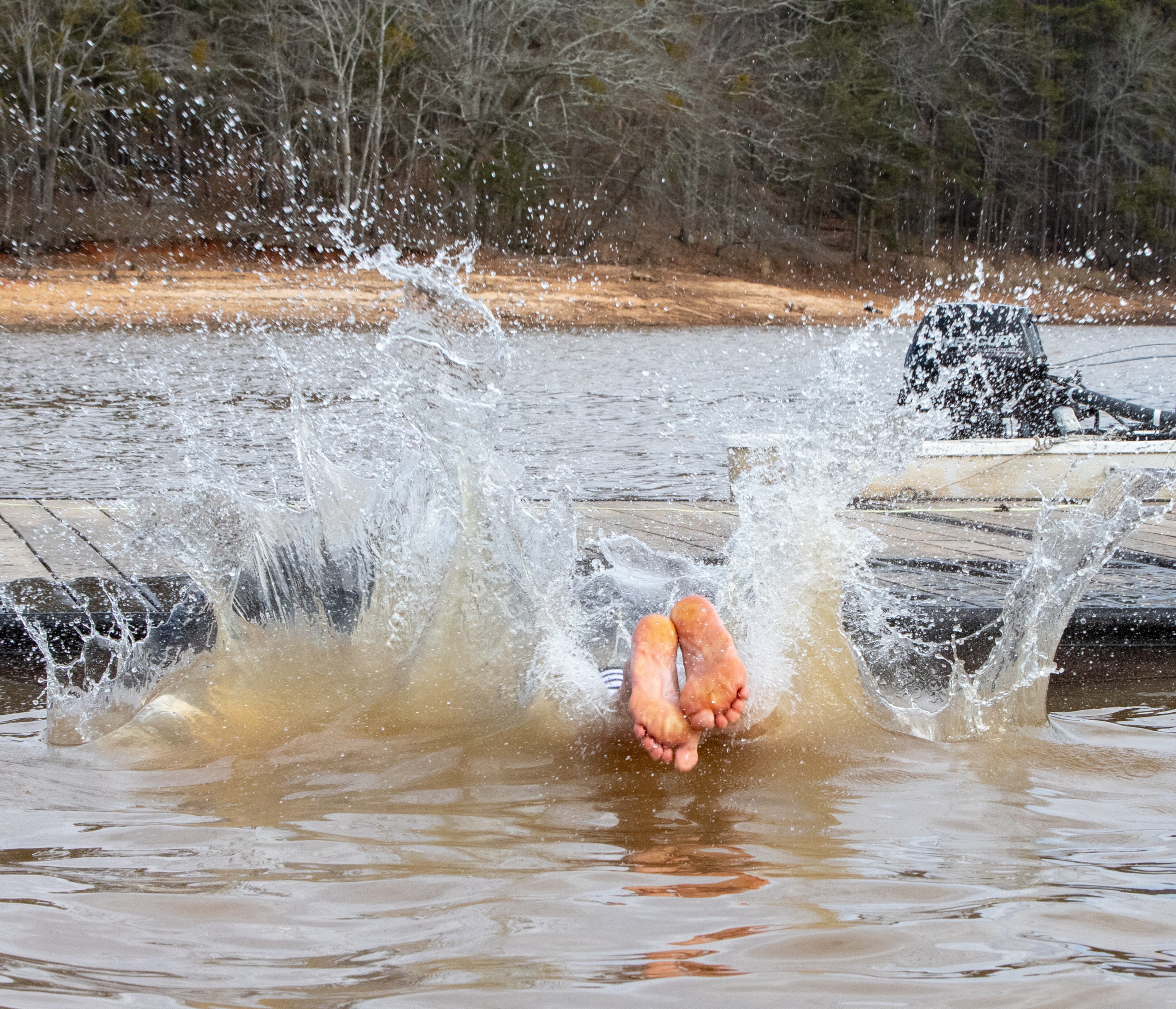 The 26th annual Polar Bear Paddle and Plunge takes place at Lake Lanier on Monday, Jan 1, 2024 where Walther Schade of Ft. Lauderdale takes a quick dip in the lake to ring in the new year. . (Jenni Girtman for The Atlanta Journal-Constitution)