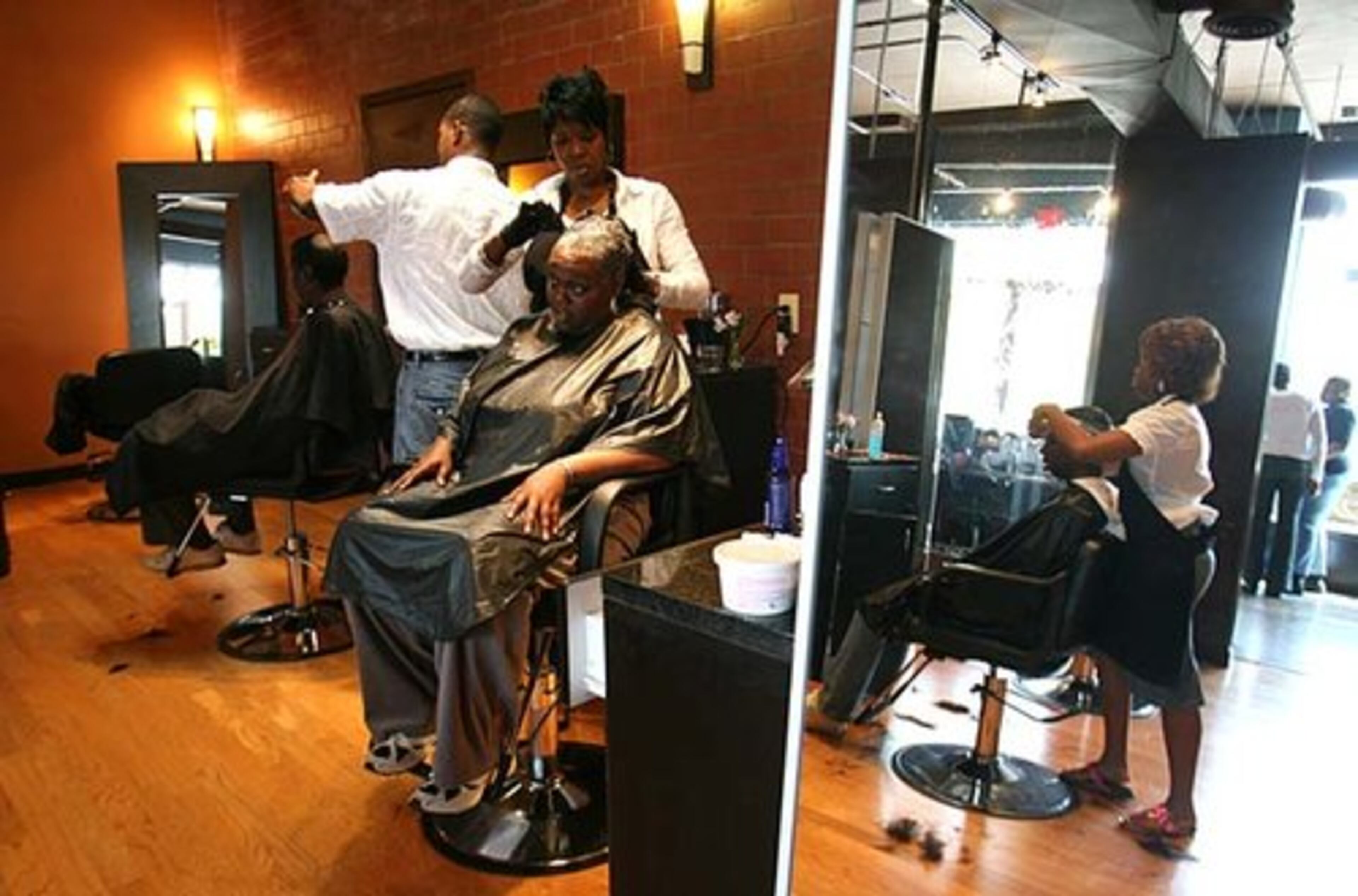 Najah Aziz puts relaxer in Judy Rawls' hair. Rawls, a mother of three, described a haircut as "a reflection of you and how you feel." She said she had not been to a salon in 10 years.