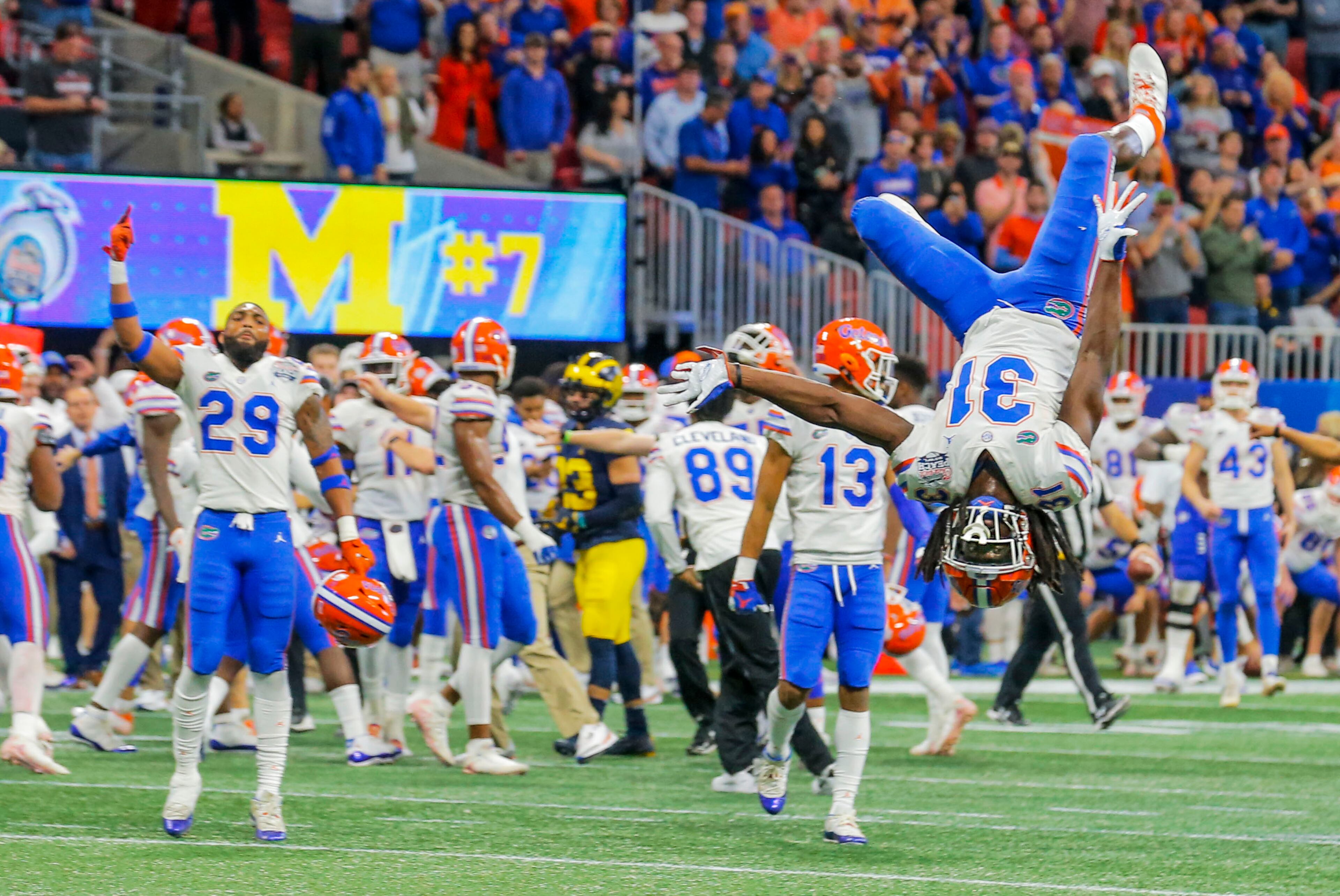 12/29/2018 -- Atlanta, Georgia -- Florida Gators defensive back Shawn Davis (31) celebrates their win over the Michigan Wolverines by doing a flip on the field during the fourth quarter of the Chick-fil-A Peach Bowl at Mercedes-Benz Stadium in Atlanta, Saturday, December 29, 2018. The Florida Gators beat the Michigan Wolverines, 41-15. (ALYSSA POINTER/ALYSSA.POINTER@AJC.COM)