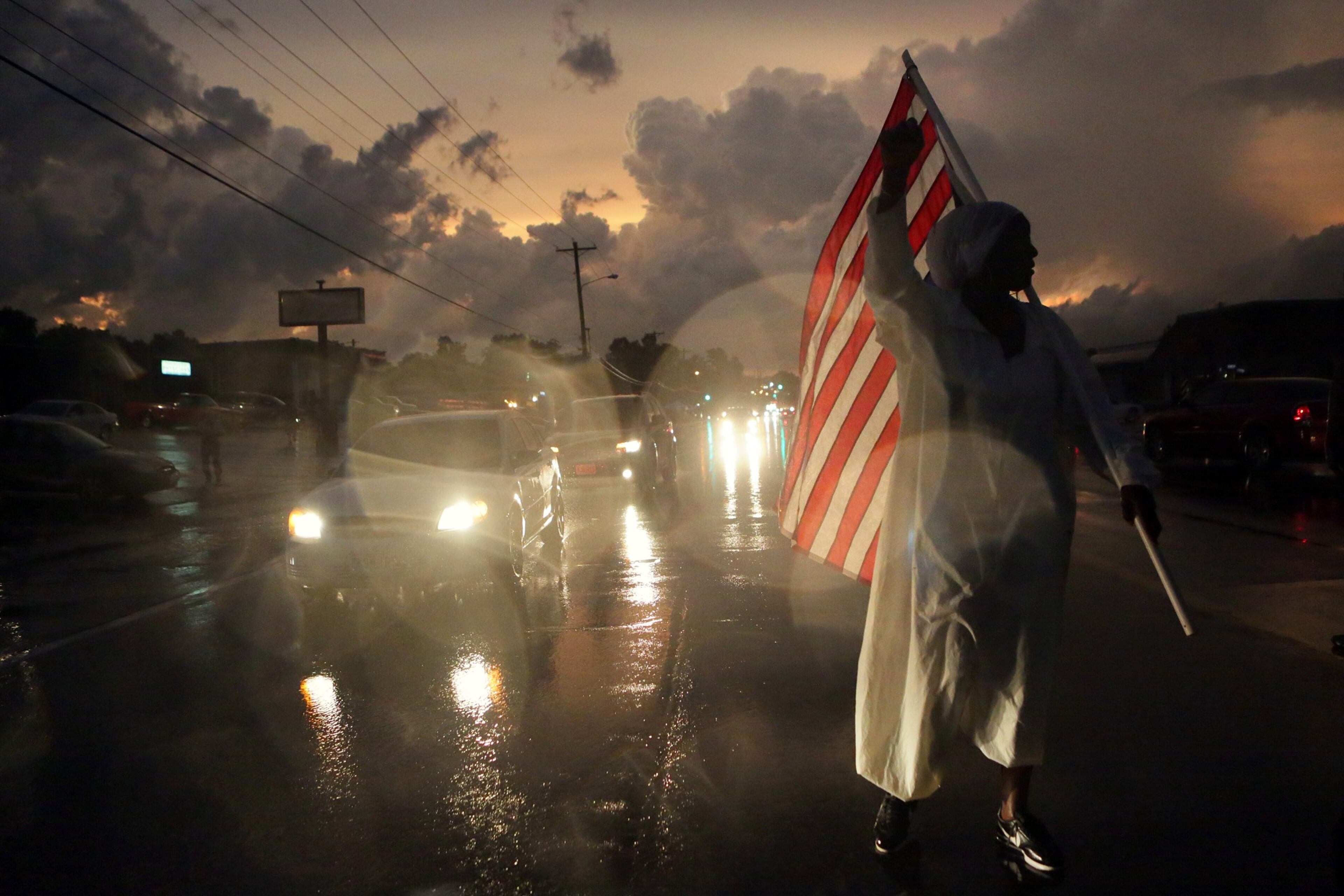 Gina Gowey, of Ferguson, Mo., protests on West Florissant Ave., Sunday, Aug. 9, 2015, in Ferguson, on the one-year anniversary of Michael Brown being shot and killed by Ferguson Police Officer Darren Wilson. (Huy Mach/St. Louis Post-Dispatch via AP) EDWARDSVILLE INTELLIGENCER OUT; THE ALTON TELEGRAPH OUT; MANDATORY CREDIT