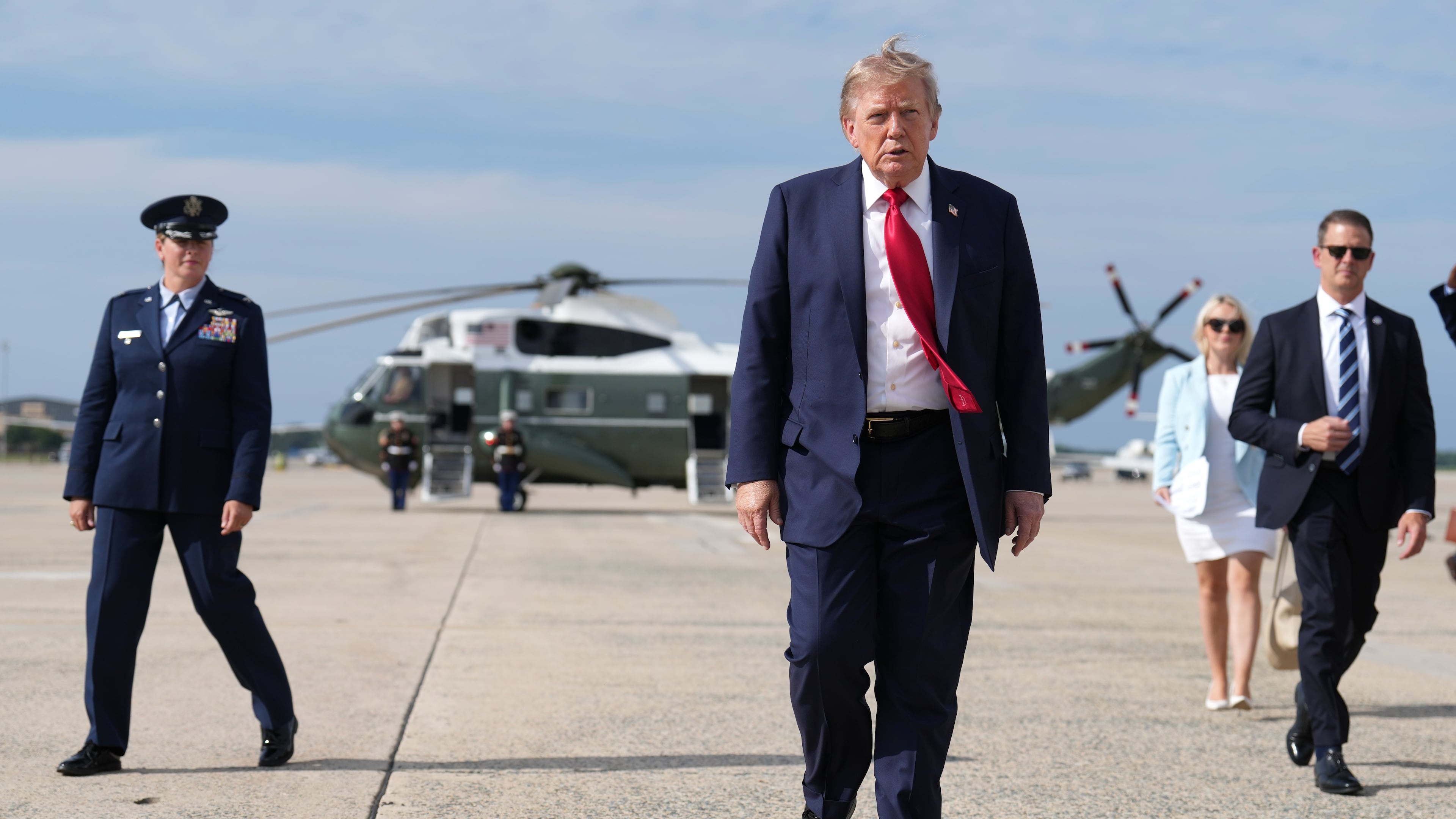 FILE - President Donald Trump, center, walks from Marine One to board Air Force One, Aug. 21, 2026, at Joint Base Andrews, Md., en route to South Carolina. (AP Photo/Jacquelyn Martin, File)