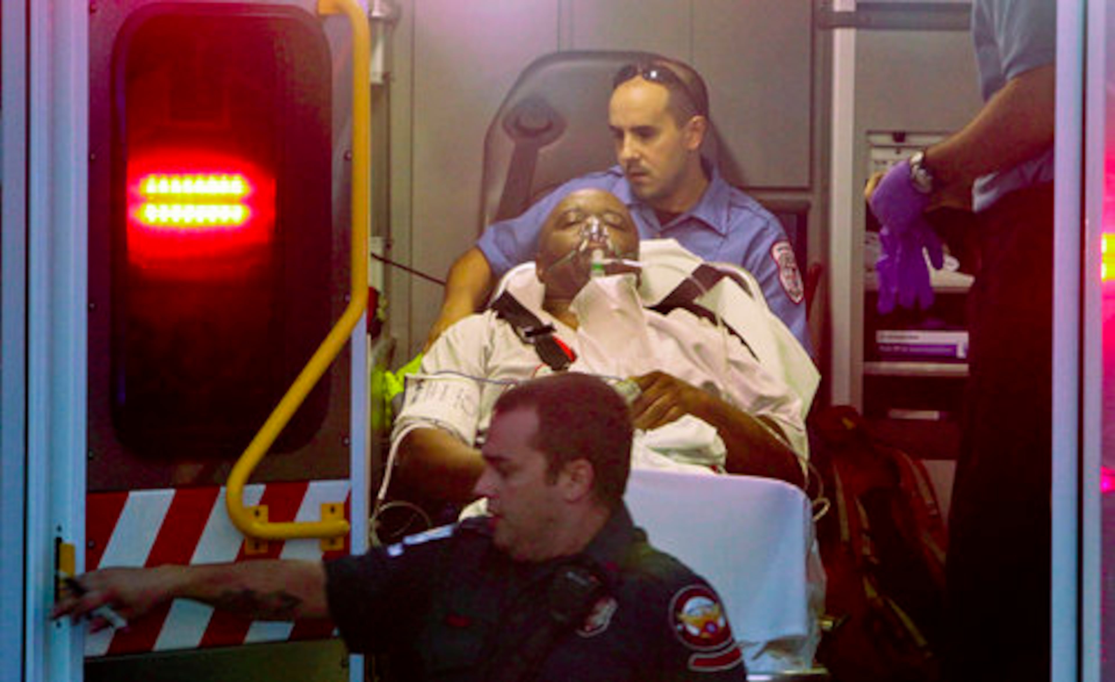 The rescued man - who was about 240 pounds - is tended to by paramedics and fire personnel before being transported to Grady Memorial Hospital for treatment of smoke inhalation and other minor injuries.