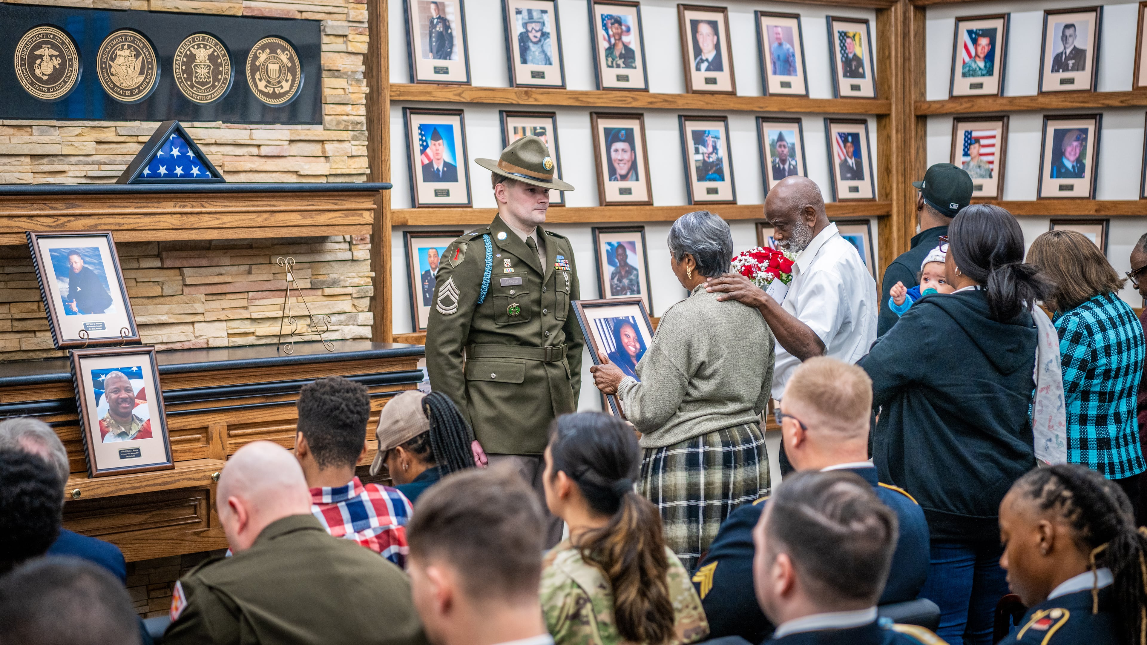 Soldiers, family members, and friends gather to honor fallen heroes at the Hall of Heroes photo mounting ceremony at the Survivor Outreach Services Center at Fort Moore on Feb. 07, 2025. Photos mounted include those of Pfc. Keon Wiliams, Staff Sgt. William J. Rivers, Sgt. 1st Class Alwyn C. Cashe and Master Sgt. Cheryl B. Harmon. (Patrick A. Albright/U.S. Army)