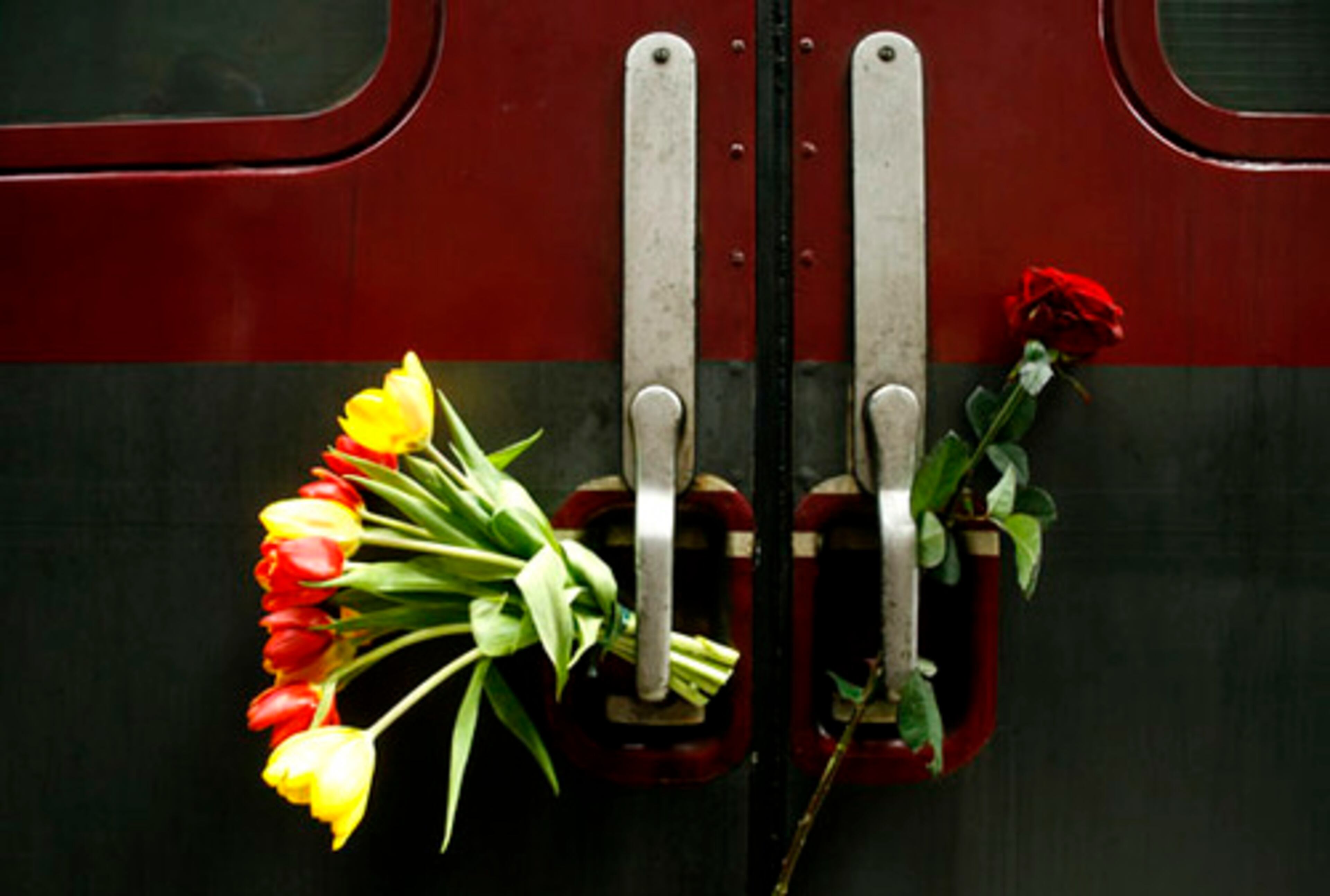 Flowers are affixed at the "Train of Commemoration" during its stop in Berlin, Germany, on Sunday. A dispute with Germany national railway operator Deutsche Bahn had threatened to prevent it from coming to the capital.