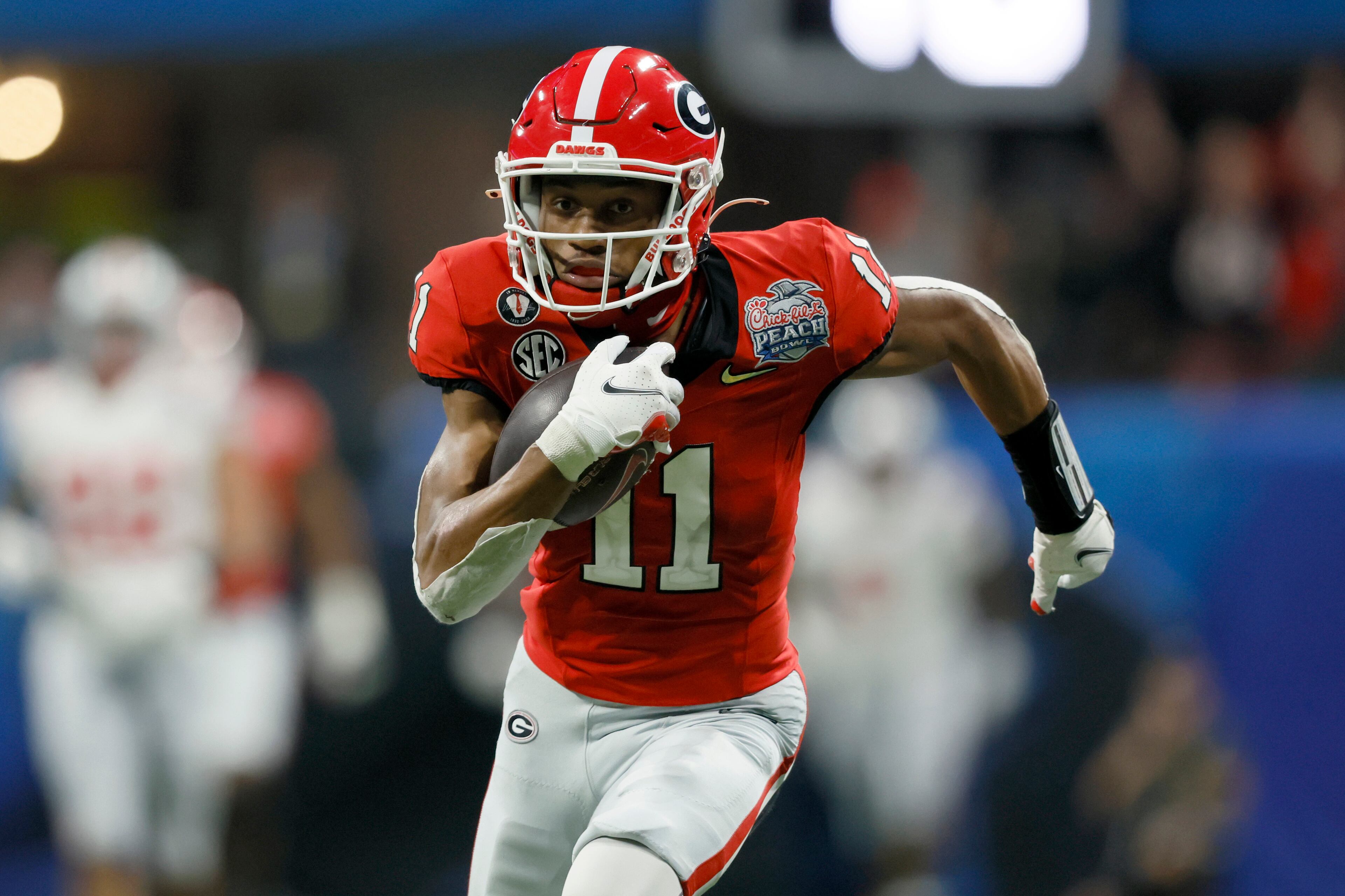 Georgia wide receiver Arian Smith (11) runs after catching a 76-yard touchdown during the fourth quarter against Ohio State in the Peach Bowl Playoff Semifinal, at Mercedes-Benz Stadium, Sat., Dec. 31, 2022, in Atlanta. Georgia won 42-41. (Jason Getz / Jason.Getz@ajc.com)