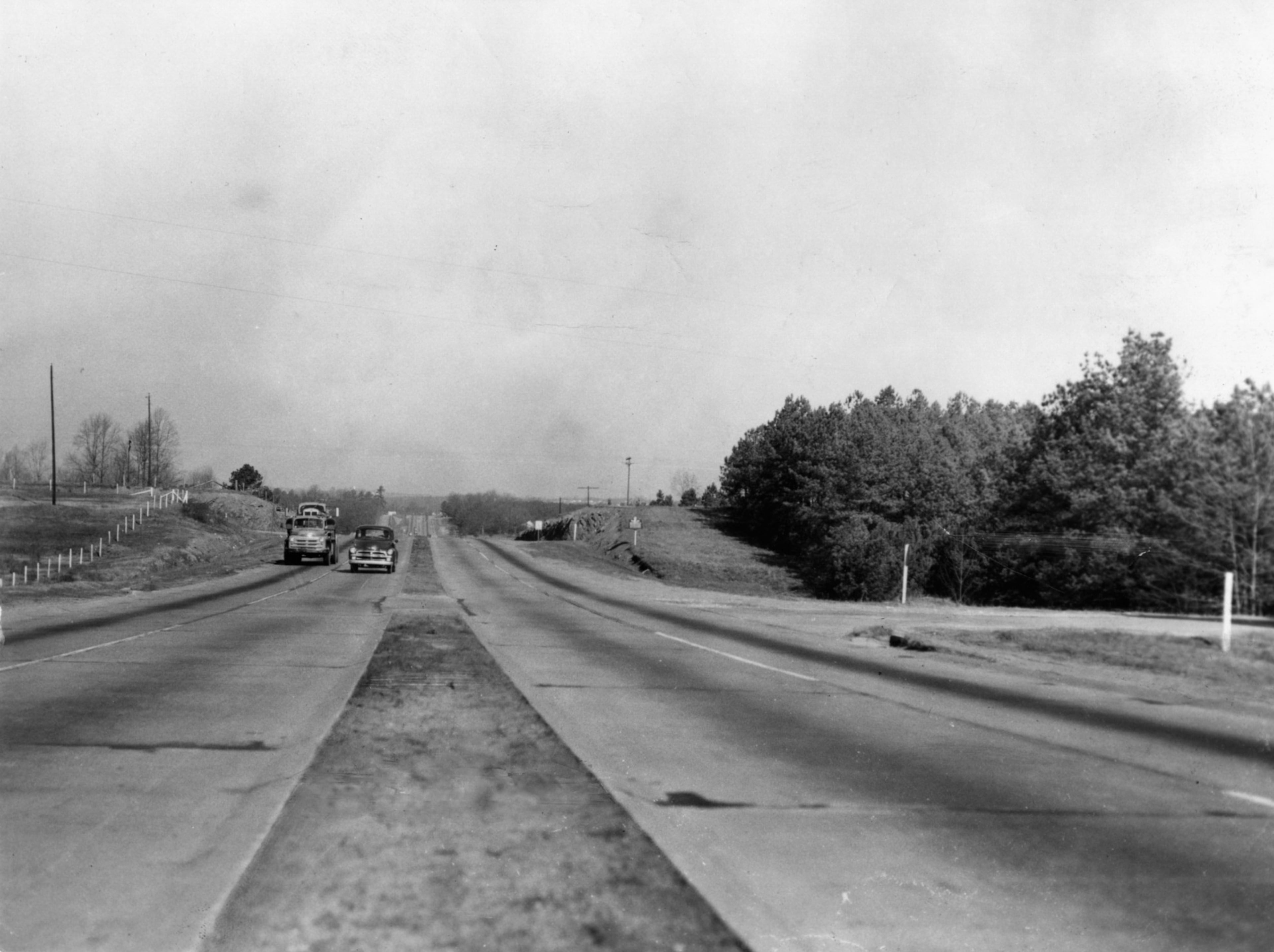Marietta Highway has many dangers as shown at the intersection of Terrell Mill Road: side road, narrow separator, narrow lanes present hazards to drivers. (1955)