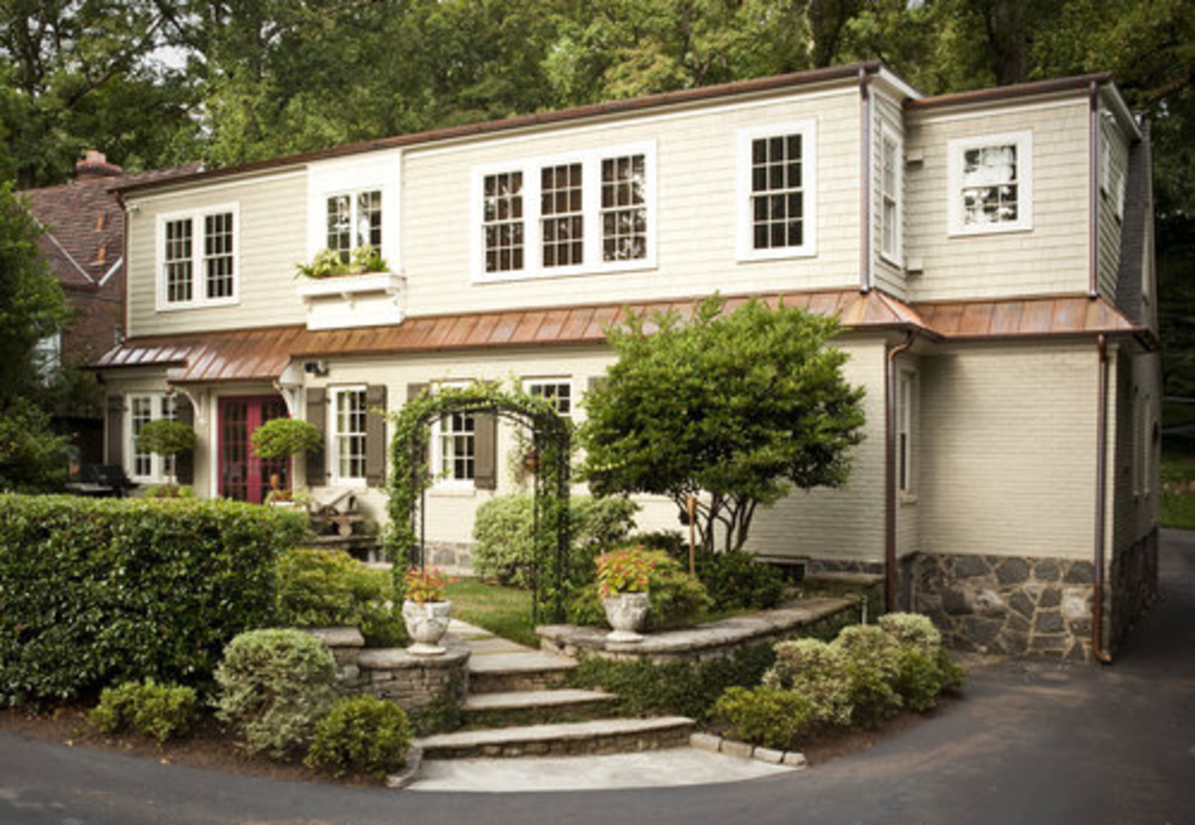 AFTER: This Home ReBuilders remodel illustrates how clever contractors and architects can mask a substantial second story addition by bumping out the back portion of the roofline, disguising the addition from the front of the home.