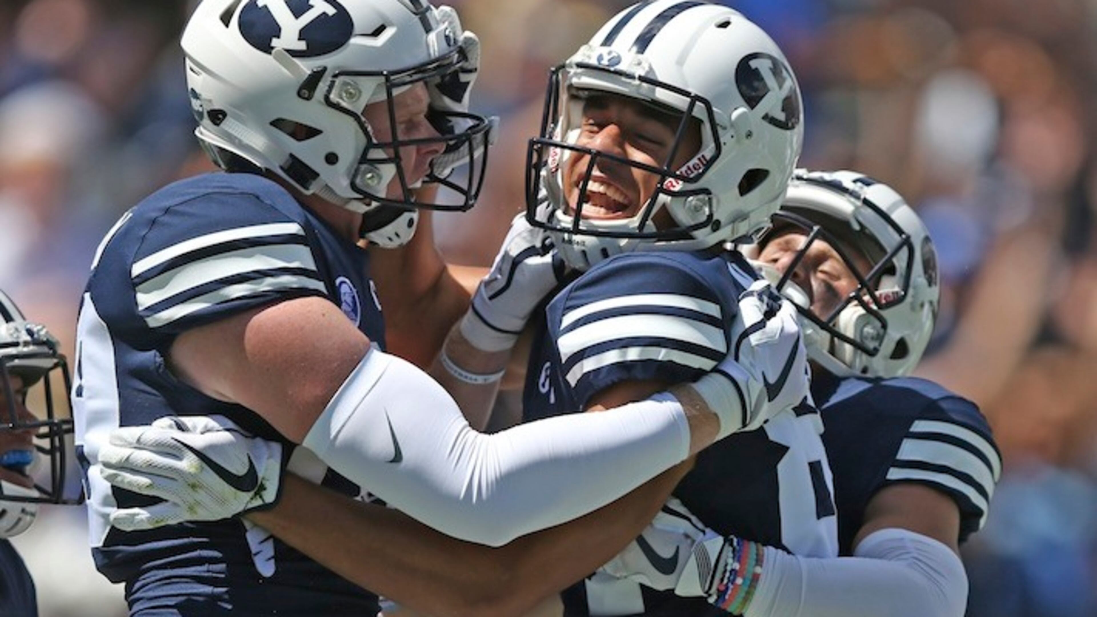 BYU wide receiver Neil Pau'u, center, celebrates his touchdown with teammates Matt Bushman, left, and Inoke Lotulelei, right, in the first half of an NCAA college football game against Portland State, Saturday, Aug. 26, 2017, in Provo, Utah. (AP Photo/Rick Bowmer)