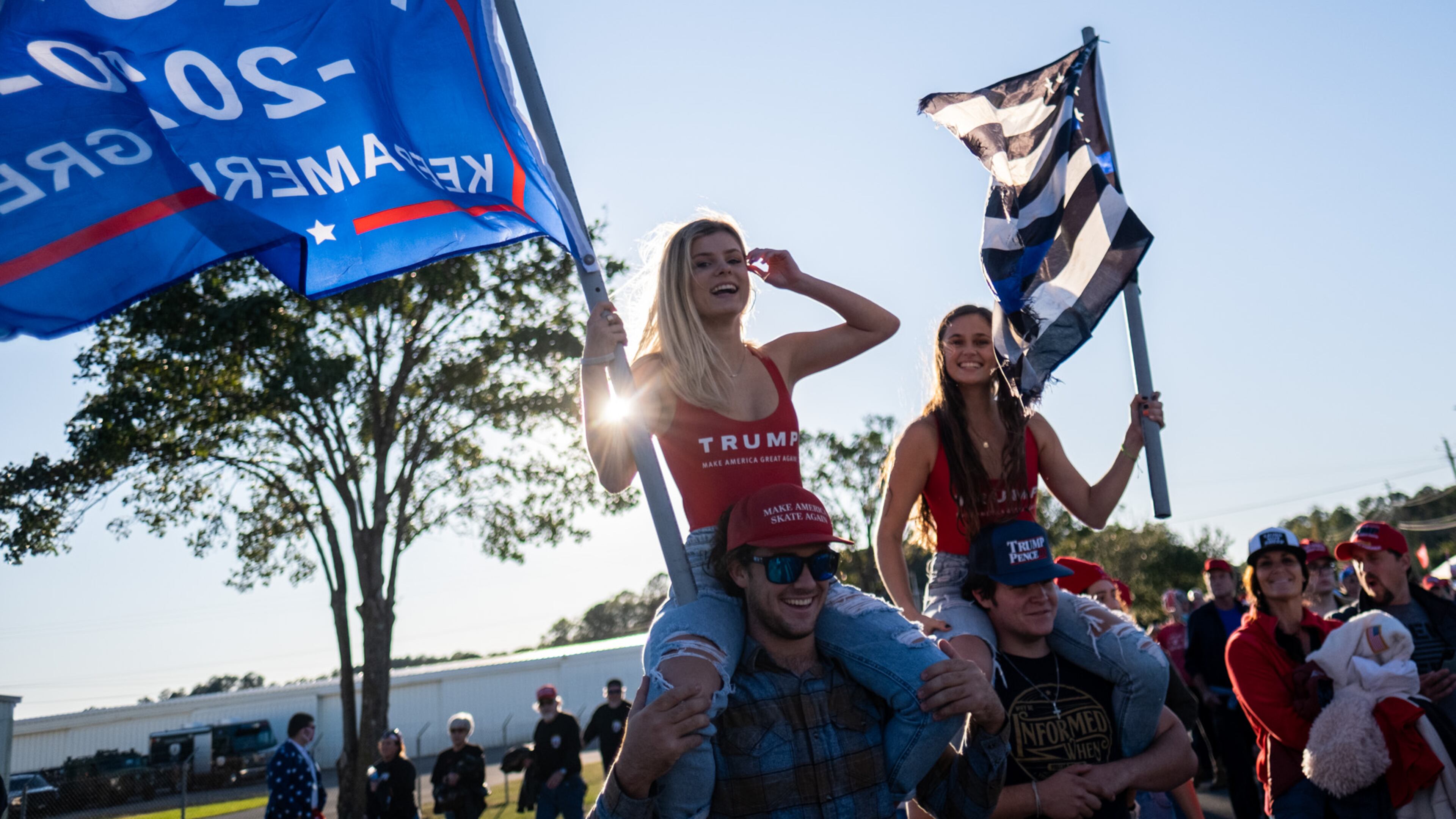 Kayden Ammerall, left, rides on Bryce Kaufman’s shoulders as Lauren Kaufman rides on Jeremiah Angel’s shoulders as they make their way toward the airport in Rome on Sunday afternoon for President Donald Trump's campaign rally. (Photo: Ben Gray for The Atlanta Journal-Constitution)