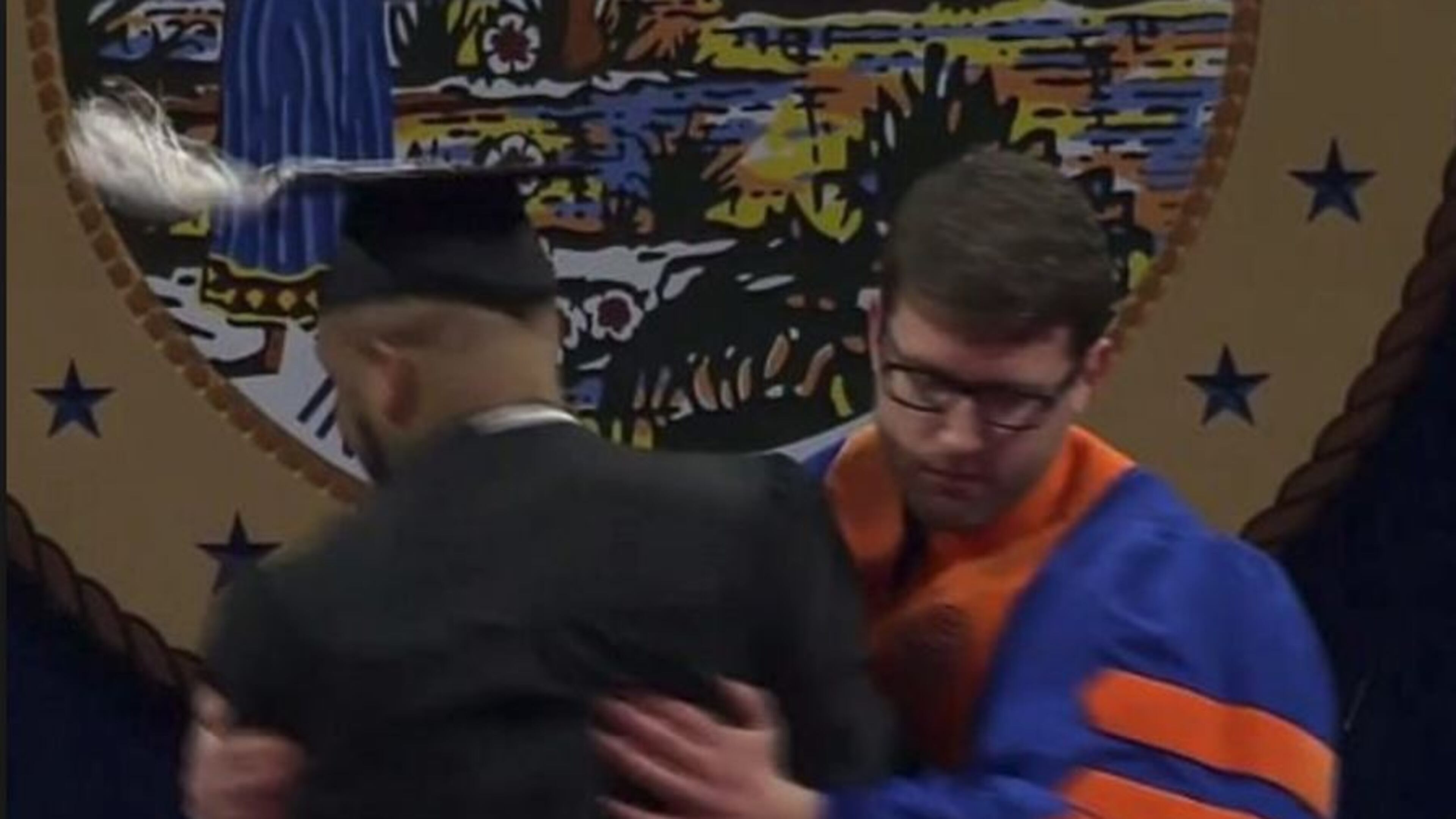 This screen grab from the University of Florida graduation shows a faculty member forcibly rushing a graduate off the stage after the student danced his way to his diploma. The university has apologized and the faculty member placed on leave.