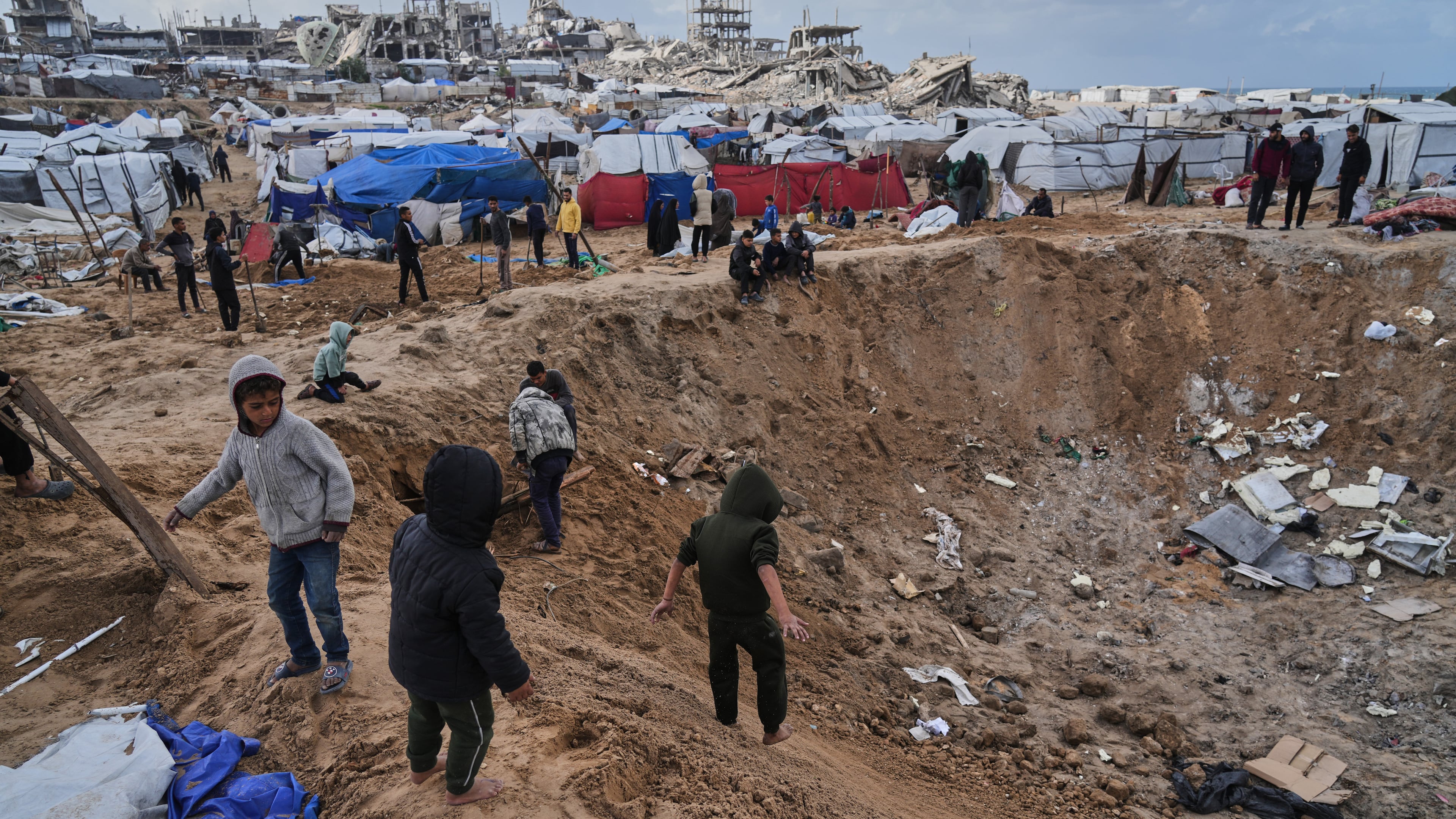 Palestinians inspect the damage at a displacement camp following an Israeli strike in Gaza City, Friday, Jan. 9, 2026. (AP Photo/Jehad Alshrafi)