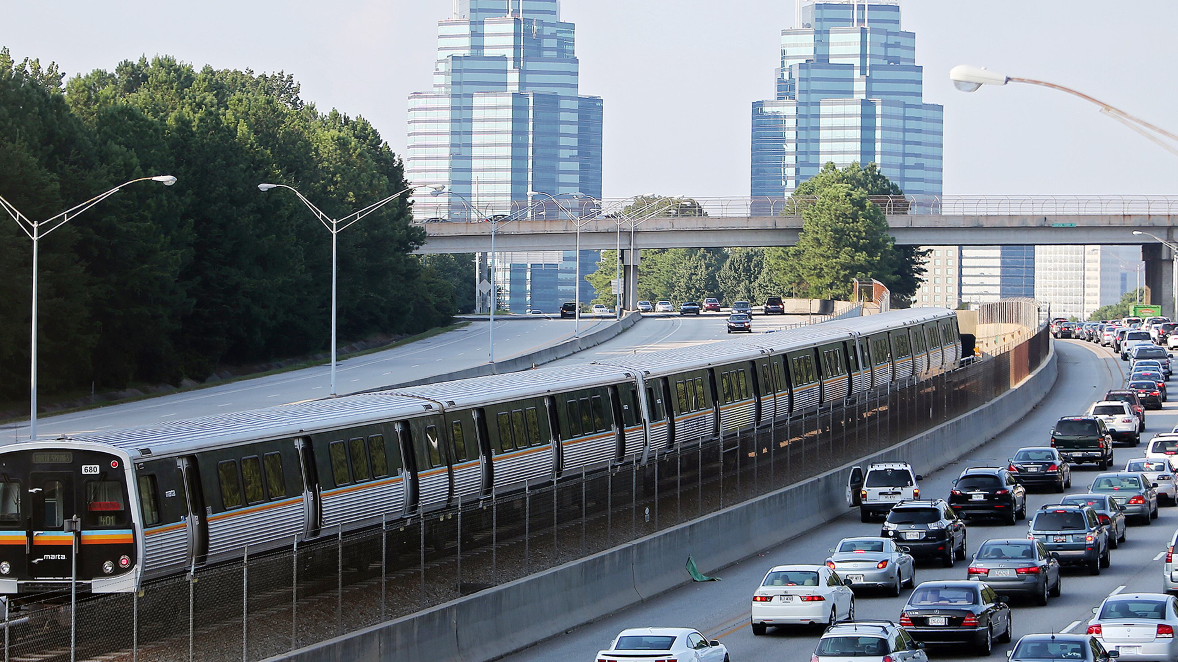 A MARTA train makes its way north past Ga. 400 traffic on a typical afternoon rush hour near Sandy Springs.