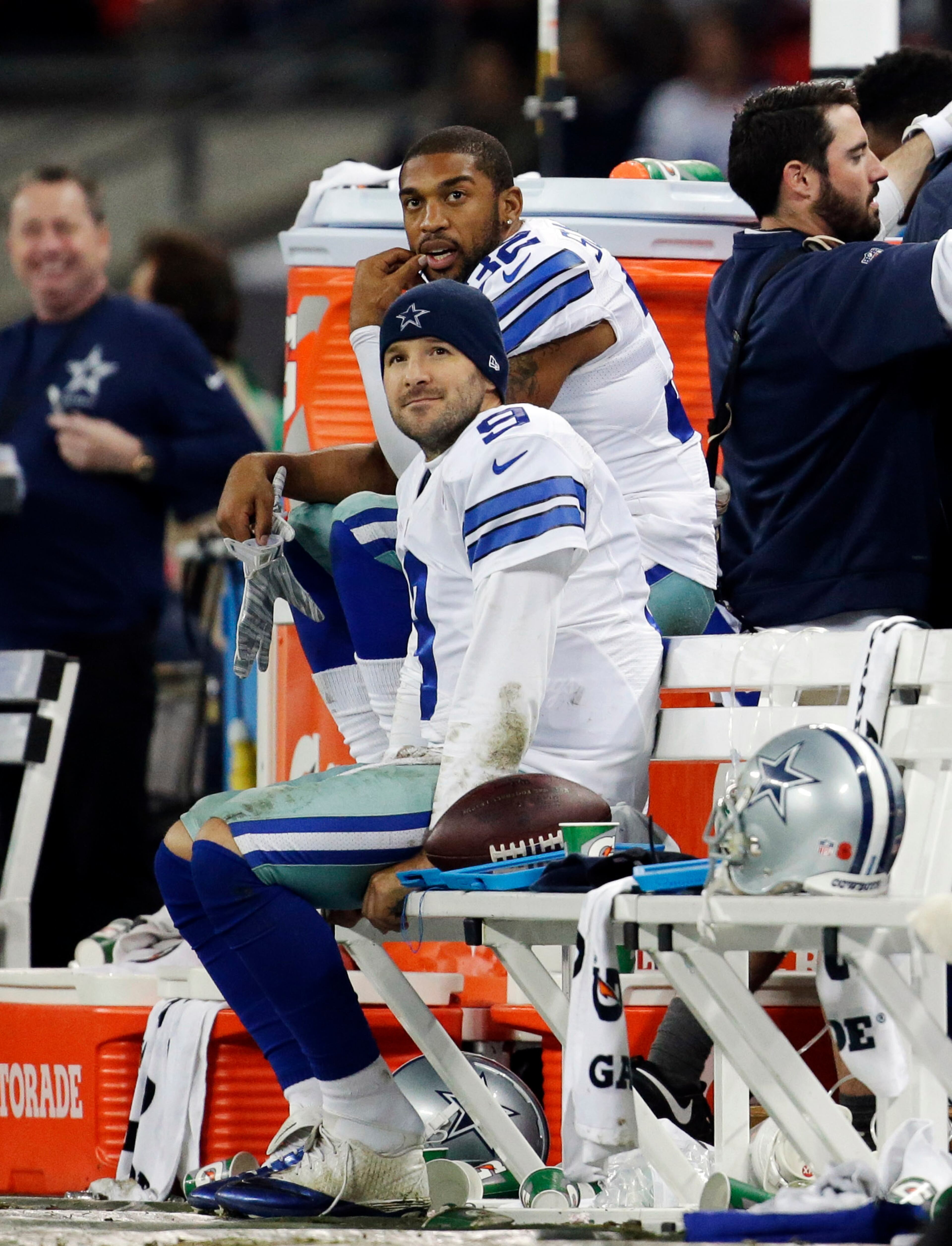 Dallas Cowboys quarterback Tony Romo sits on the side lines with Orlando Scandrick (32) during the second half of an NFL football game against the Jacksonville Jaguars at Wembley Stadium, London, Sunday, Nov. 9, 2014. The Cowboys defeated the Jaguars 31-17. (AP Photo/Matt Dunham)