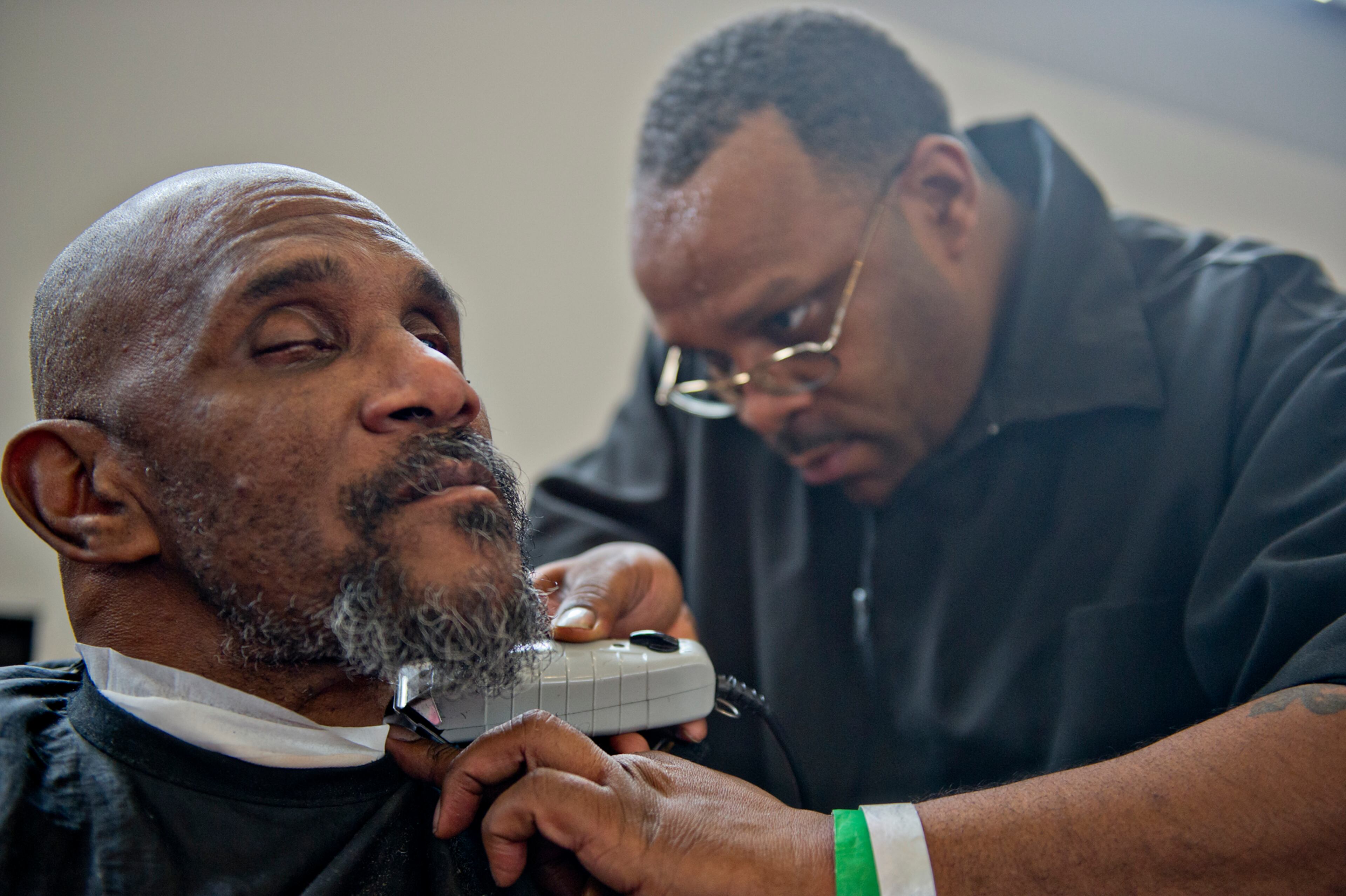 Earl Thompson (left) gets his beard trimmed by Christopher Clark during the 44th annual Hosea Feed the Hungry and Homeless Holiday Dinner Thursday at the Georgia World Congress Center.