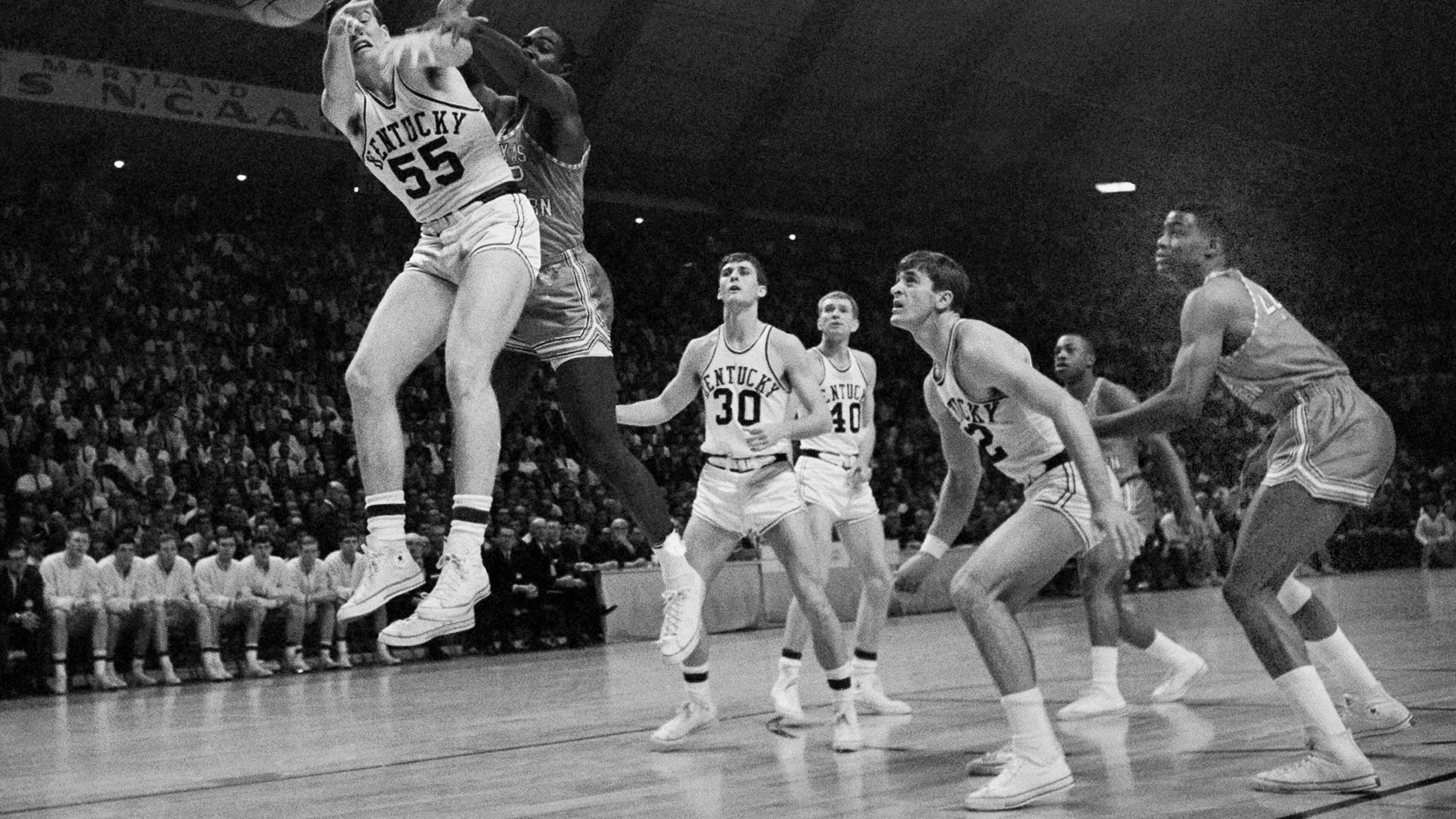 In this March 19, 1966, file photo, Kentucky’s Thad Jaracz (55) and Texas Western’s David Lattn (42) reach for a rebound during the first half of the NCAA men’s baksetball championship game in College Park, Md. Kentucky’s Pat Riley is in the foreground. Other Kentucky players shown are Tommy Kron (30) and Larry Conley (40). (AP Photo/File)
