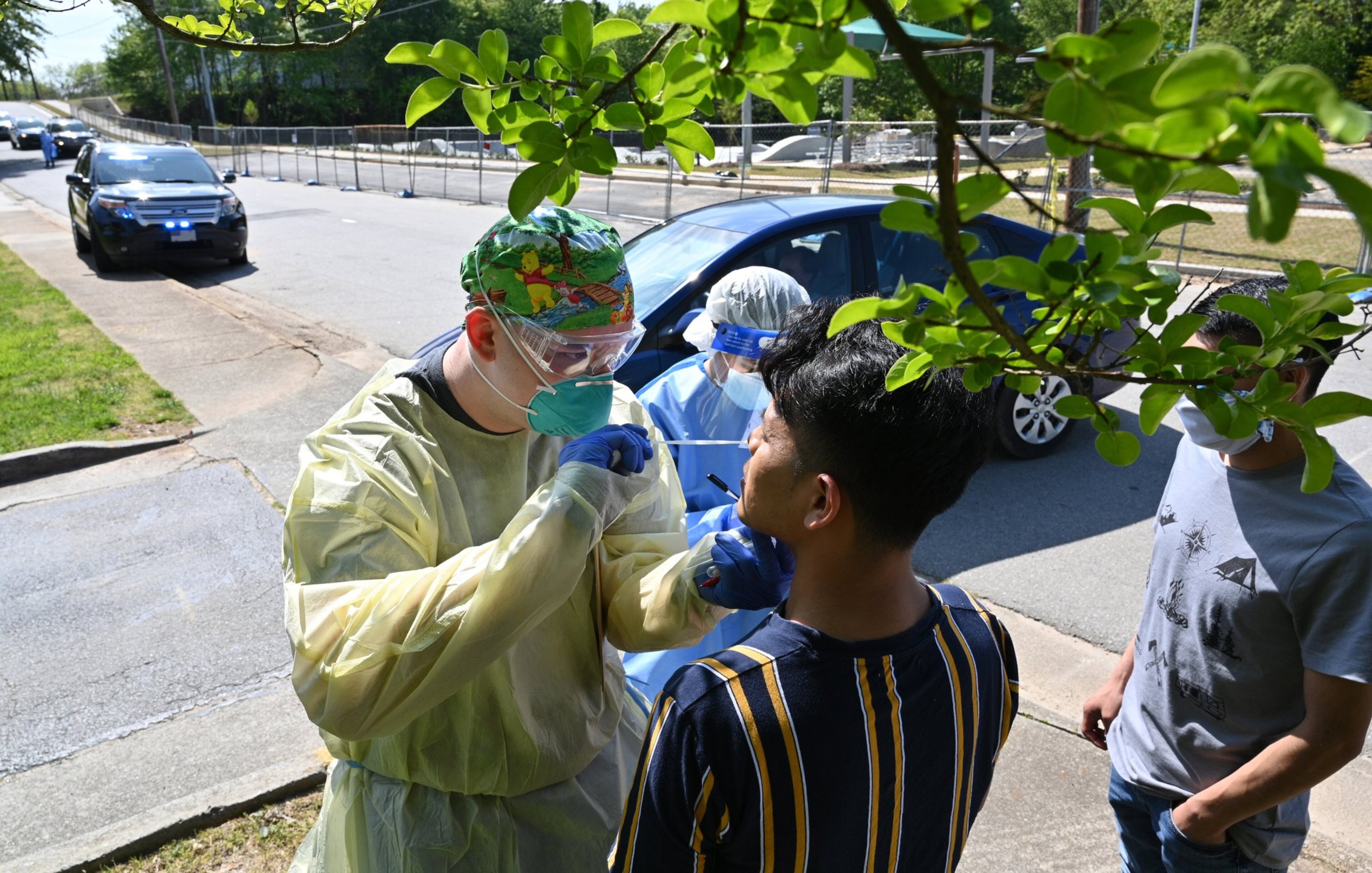 A medical professional collects a nasal swab from a potential COVID-19 patient who just walked in at a drive-through COVID-19 testing site at Good News Clinic in Gainesville on Tuesday, April 28, 2020. HYOSUB SHIN / HYOSUB.SHIN@AJC.COM