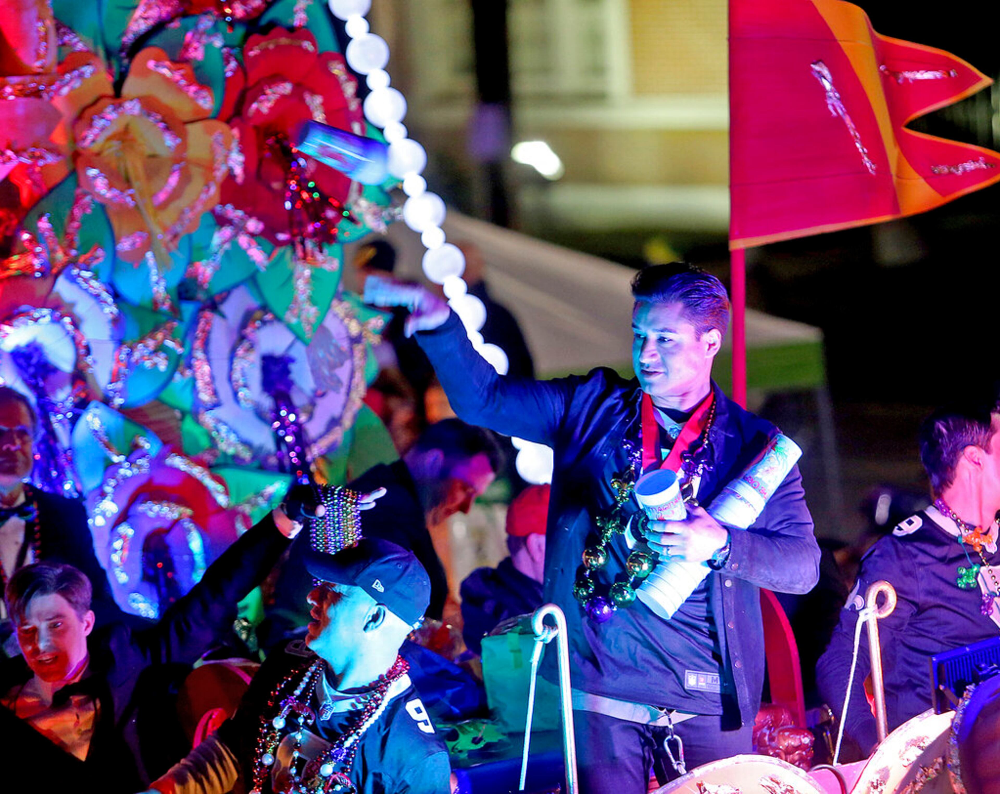 Monarch Mario Lopez throws to the crowd on Napoleon Avenue as the 1,400 men and women of the Krewe of Orpheus present a 38-float Mardi Gras parade entitled "The Orpheus Imaginarium" on the Uptown parade route in New Orleans on Monday, March 4, 2019. (Michael DeMocker/The Times-Picayune via AP)