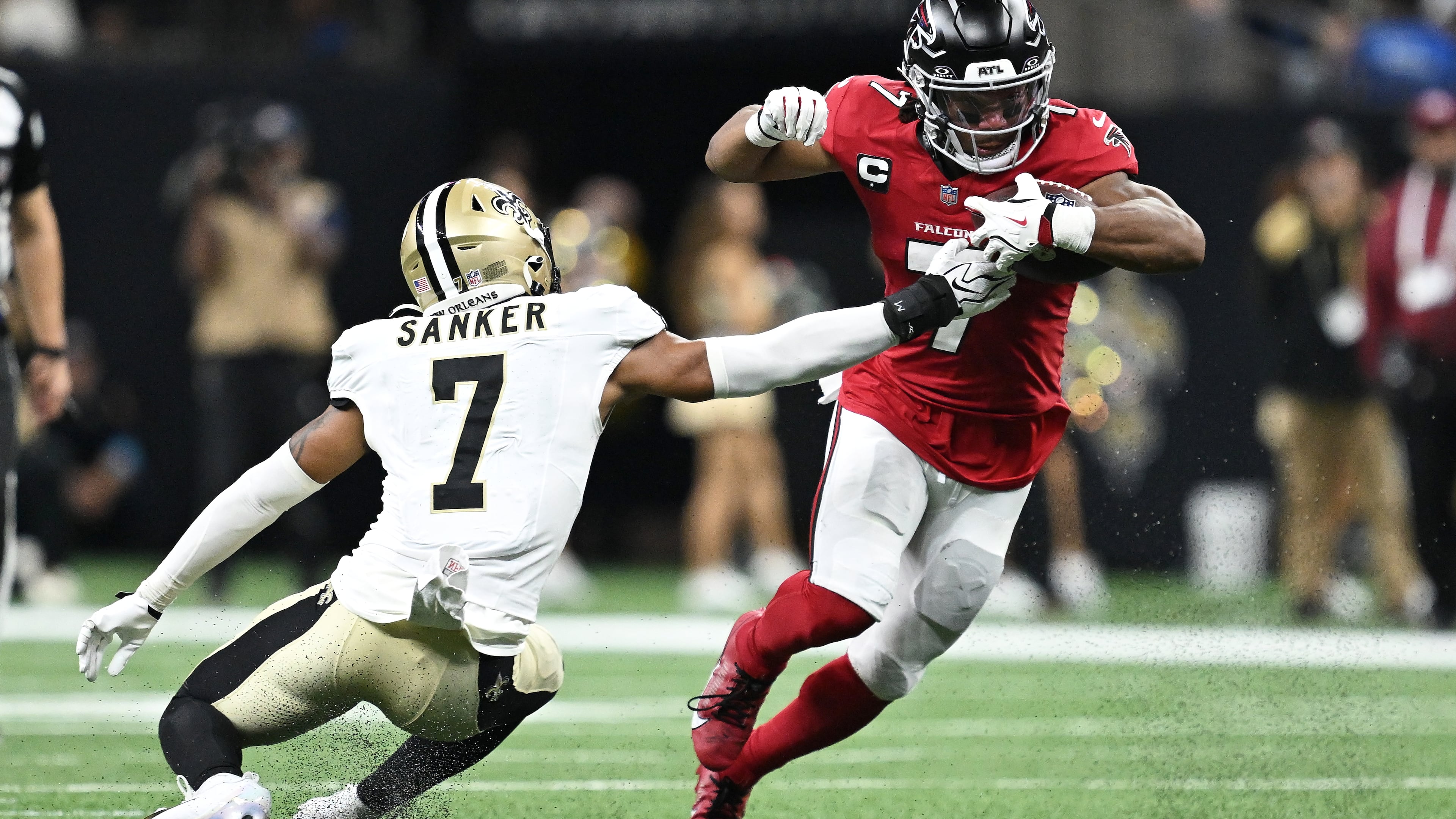 Atlanta Falcons running back Bijan Robinson (right) runs against New Orleans Saints safety Jonas Sanker during the first half of an NFL football game in New Orleans, Monday, Oct. 5, 2026. (Ella Hall/AP)