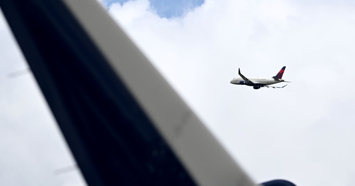 A Boeing passenger jet parked on an airport taxiway with emergency slides deployed and first responders nearby.