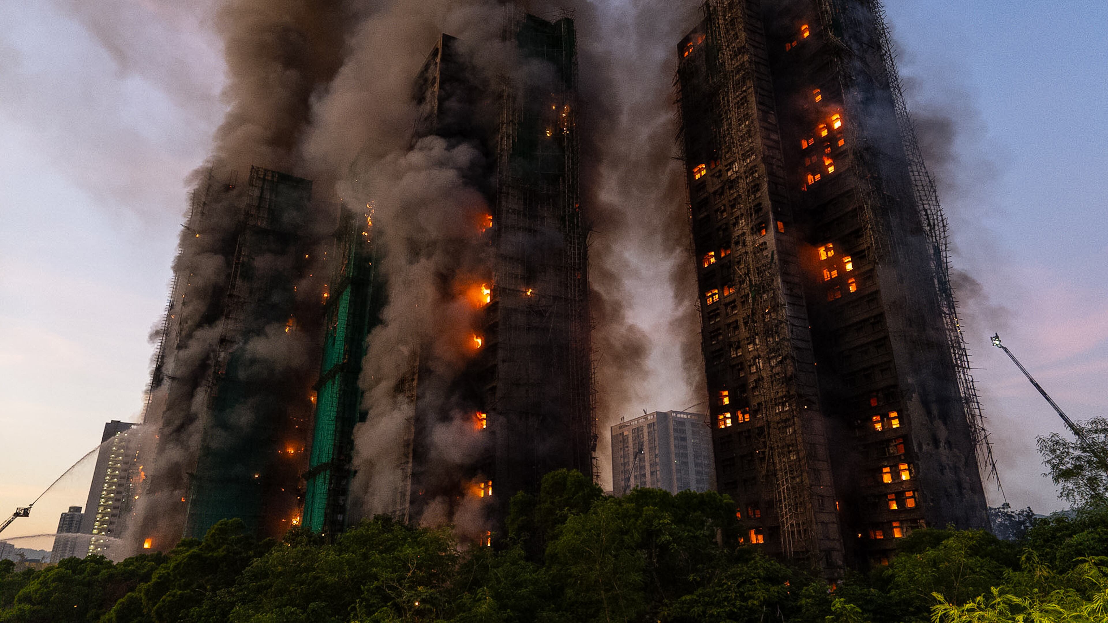 FILE - Smoke rises after a fire broke out at Wang Fuk Court, a residential estate in the Tai Po district of Hong Kong's New Territories, Nov. 26 2025. (AP Photo/Chan Long Hei, File)