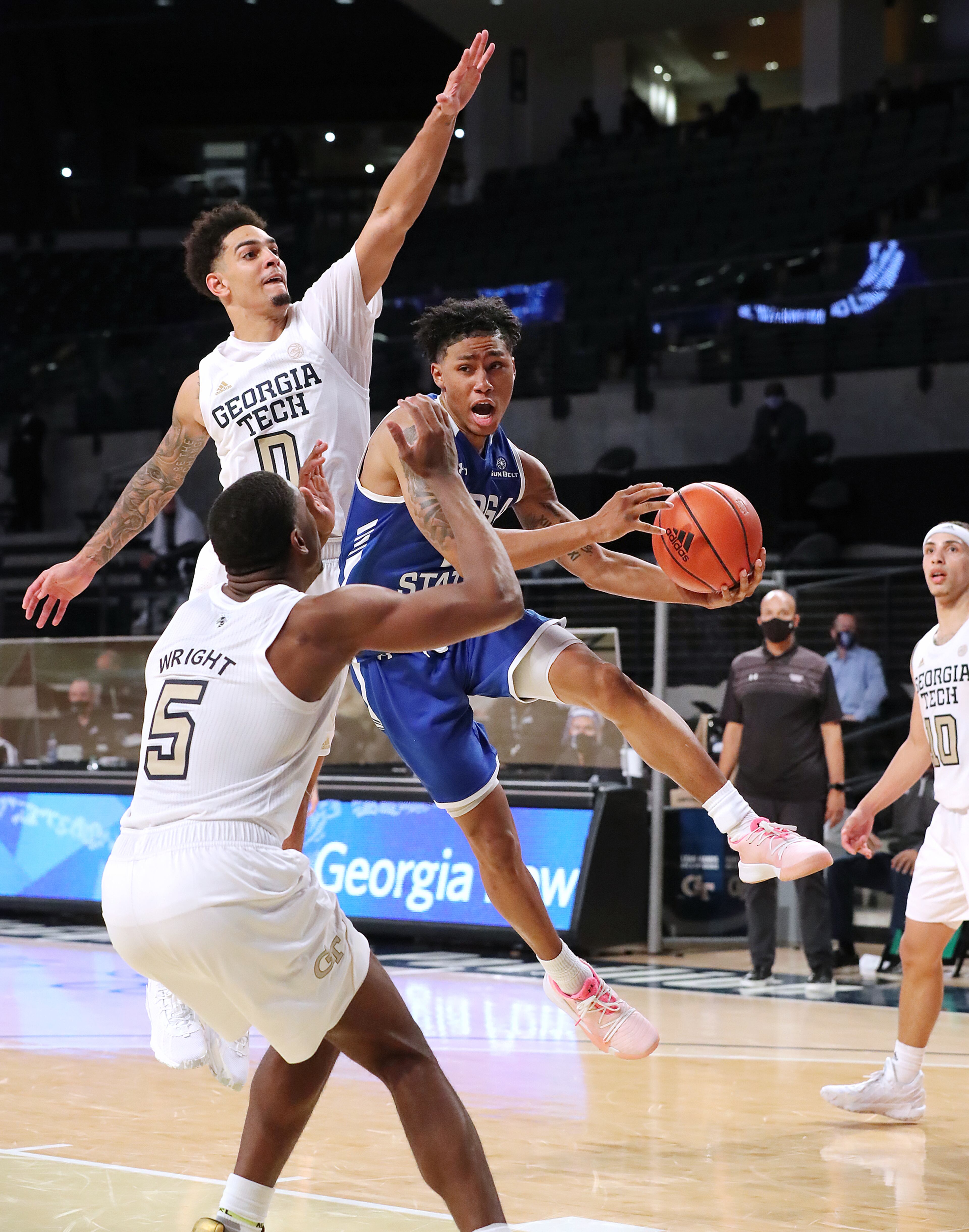 Georgia Tech defenders Moses Wright and Michael Devoe force Georgia State guard Justin Roberts to pass off under the basket in the fourth overtime. “Curtis Compton / Curtis.Compton@ajc.com”