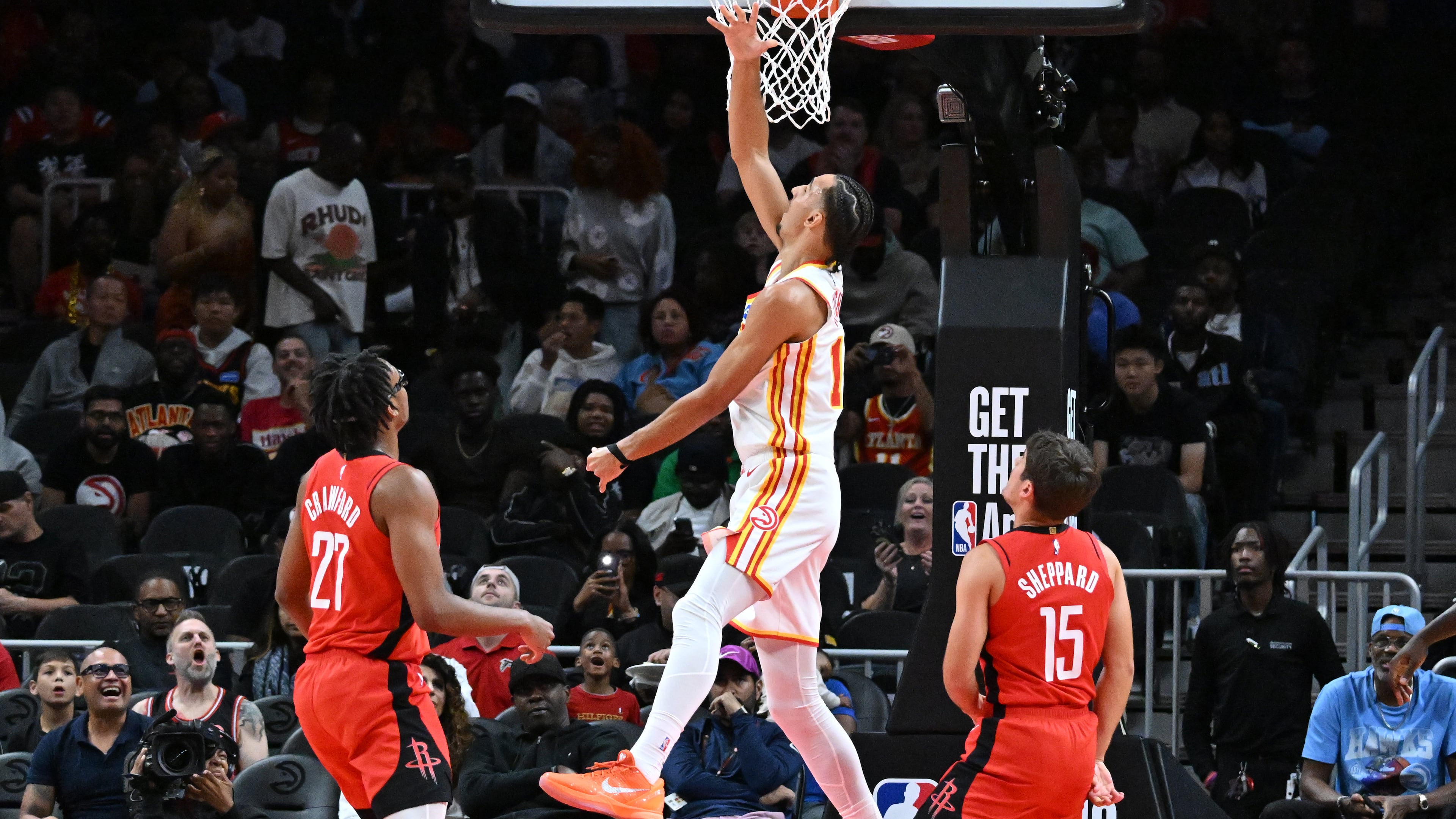 Atlanta Hawks forward Zaccharie Risacher (center) goes to the basket for the shot during the first half in a preseason NBA basketball game at State Farm Arena, Thursday, October 16, 2025, in Atlanta. Houston Rockets won 133-115 over Atlanta Hawks. (Hyosub Shin/AJC)