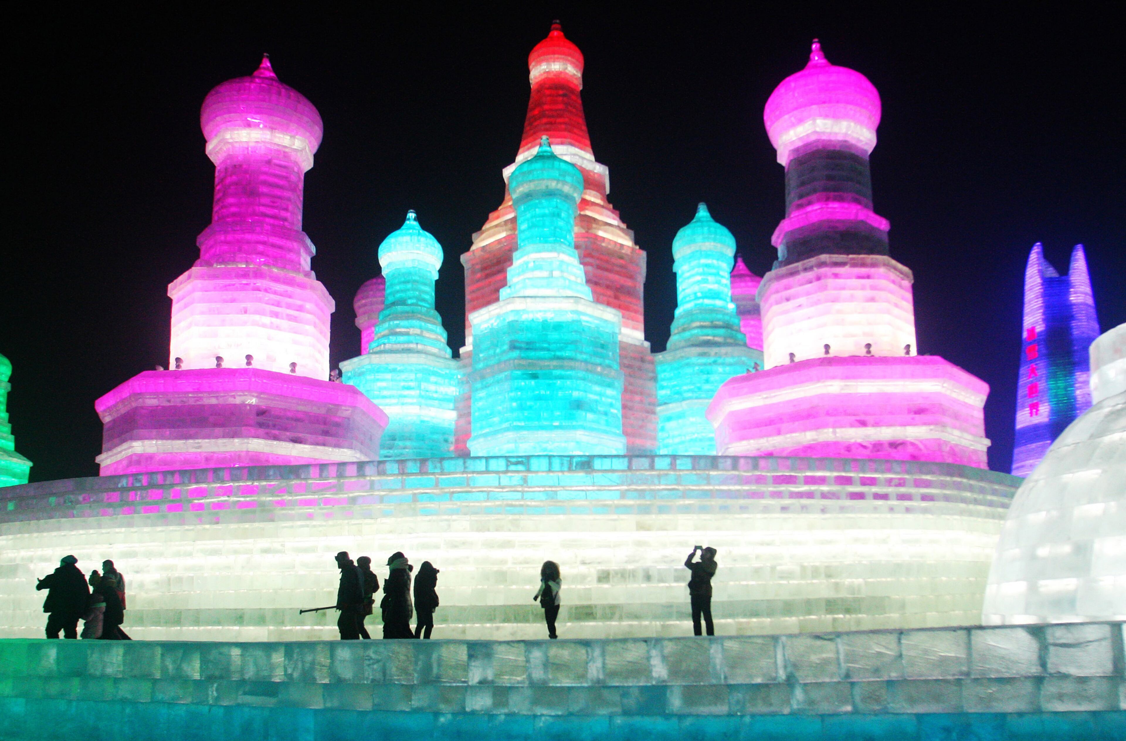 HARBIN, CHINA - DECEMBER 22: (CHINA OUT) Tourists play in the Harbin Ice And Snow World during its test run on December 22, 2015 in Harbin, Heilongjiang Province of China. The 17th Harbin Ice And Snow World would run from December 25, 2015 to February 25, 2016. (Photo by ChinaFotoPress/ChinaFotoPress via Getty Images)