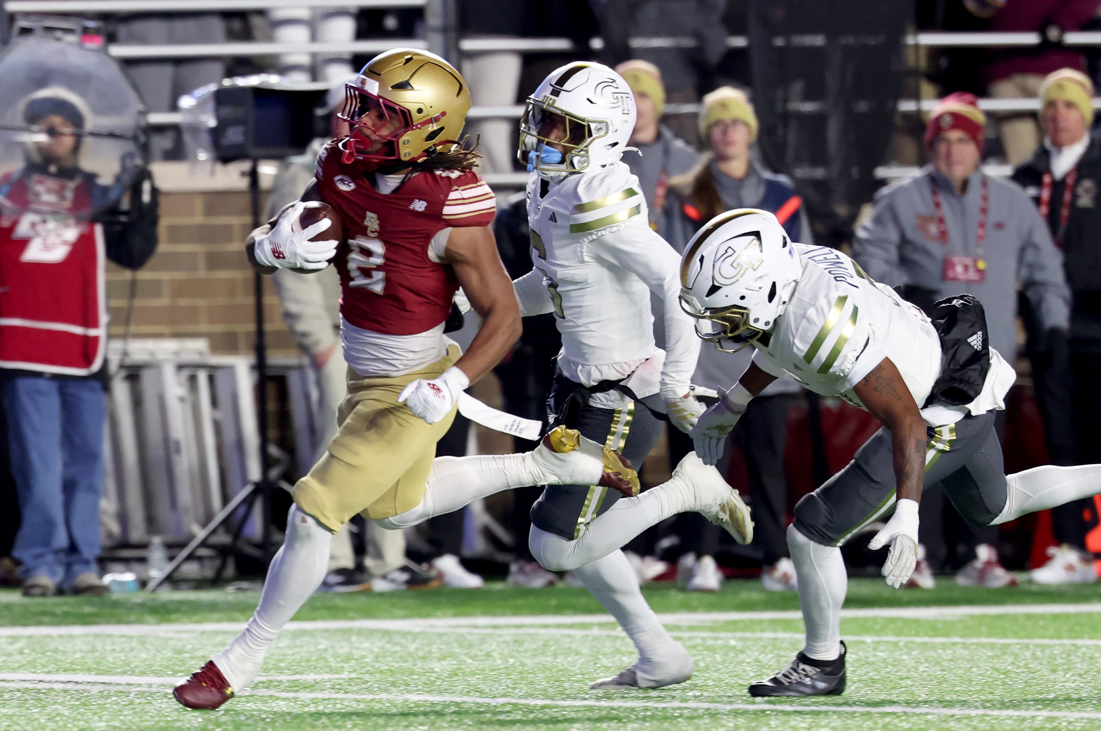 Boston College running back Turbo Richard, left, runs for a touchdown as Georgia Tech defensive backs Rodney Shelley, center, and Clayton Powell-Lee, right, pursue during the second half of an NCAA college football game Saturday, Nov. 15, 2025, in Boston. (AP Photo/Mark Stockwell)