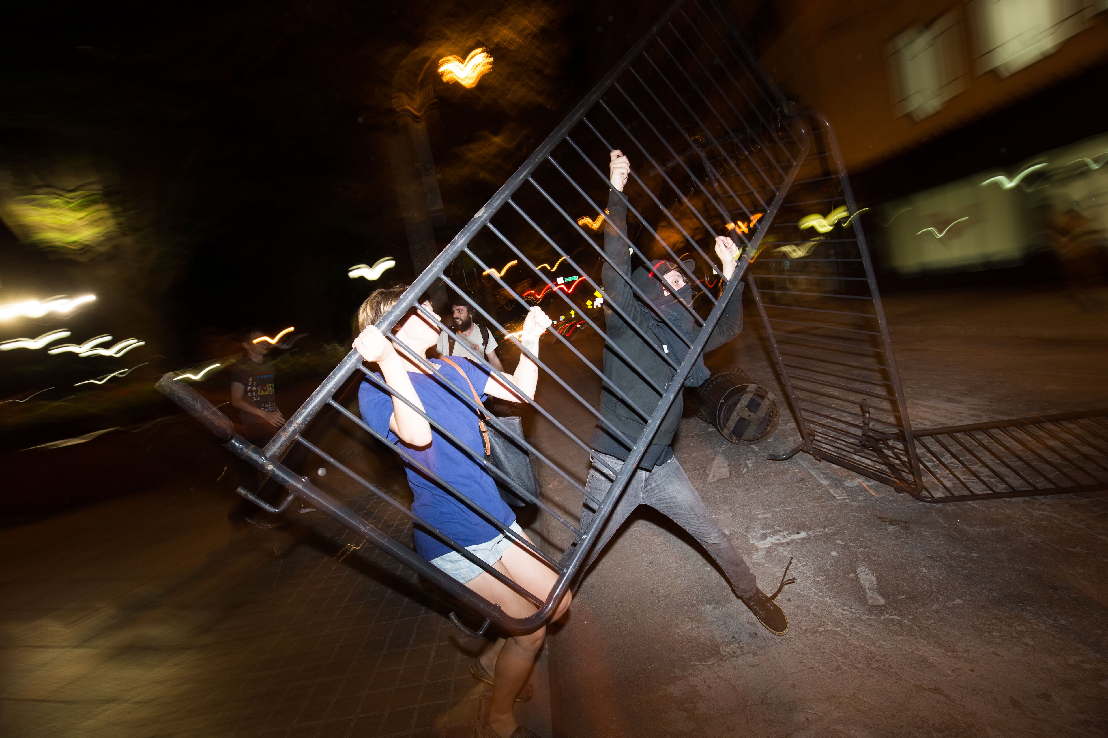Demonstrators throw gates in the street near Woodruff Park, Thursday, July 7, 2016, in Atlanta, in response to the death of Alton Sterling, 37, who was killed by Baton Rouge police outside of a convenience store where he was selling CDs, and Philando Castile, who was shot and killed when Minnesota police stopped him for a traffic violation on Wednesday evening. BRANDEN CAMP/SPECIAL