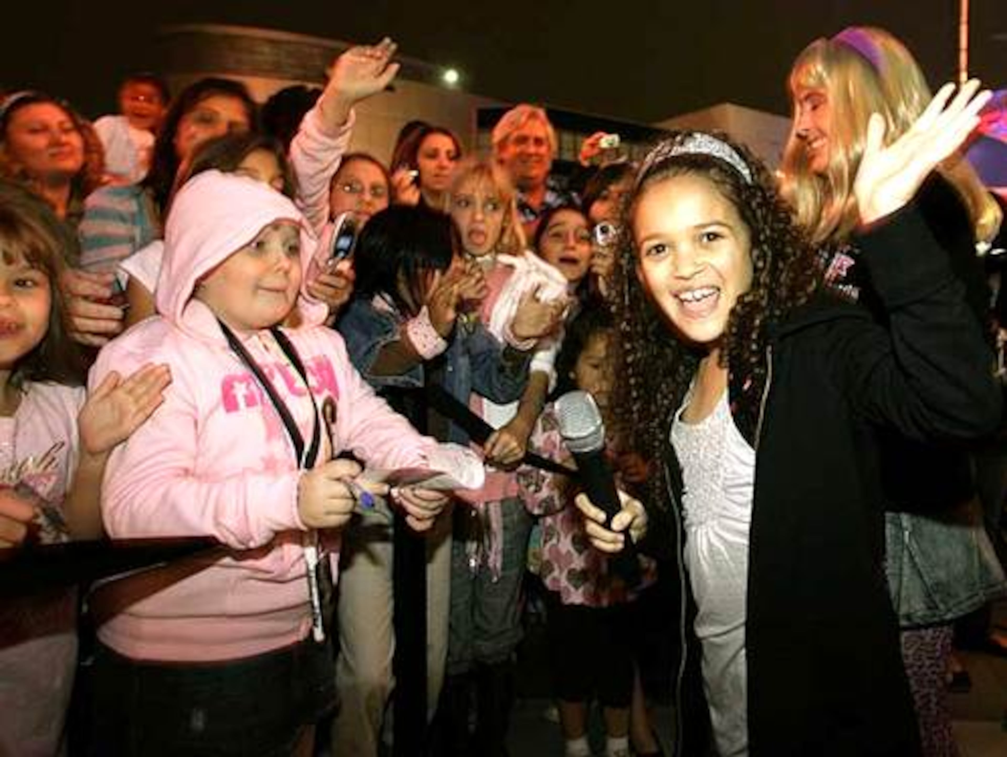 Actress Madison Pettis of The Disney Channel's series "Cory in the House" waves while singing with the crowd at the Miley Cyrus party in LA.