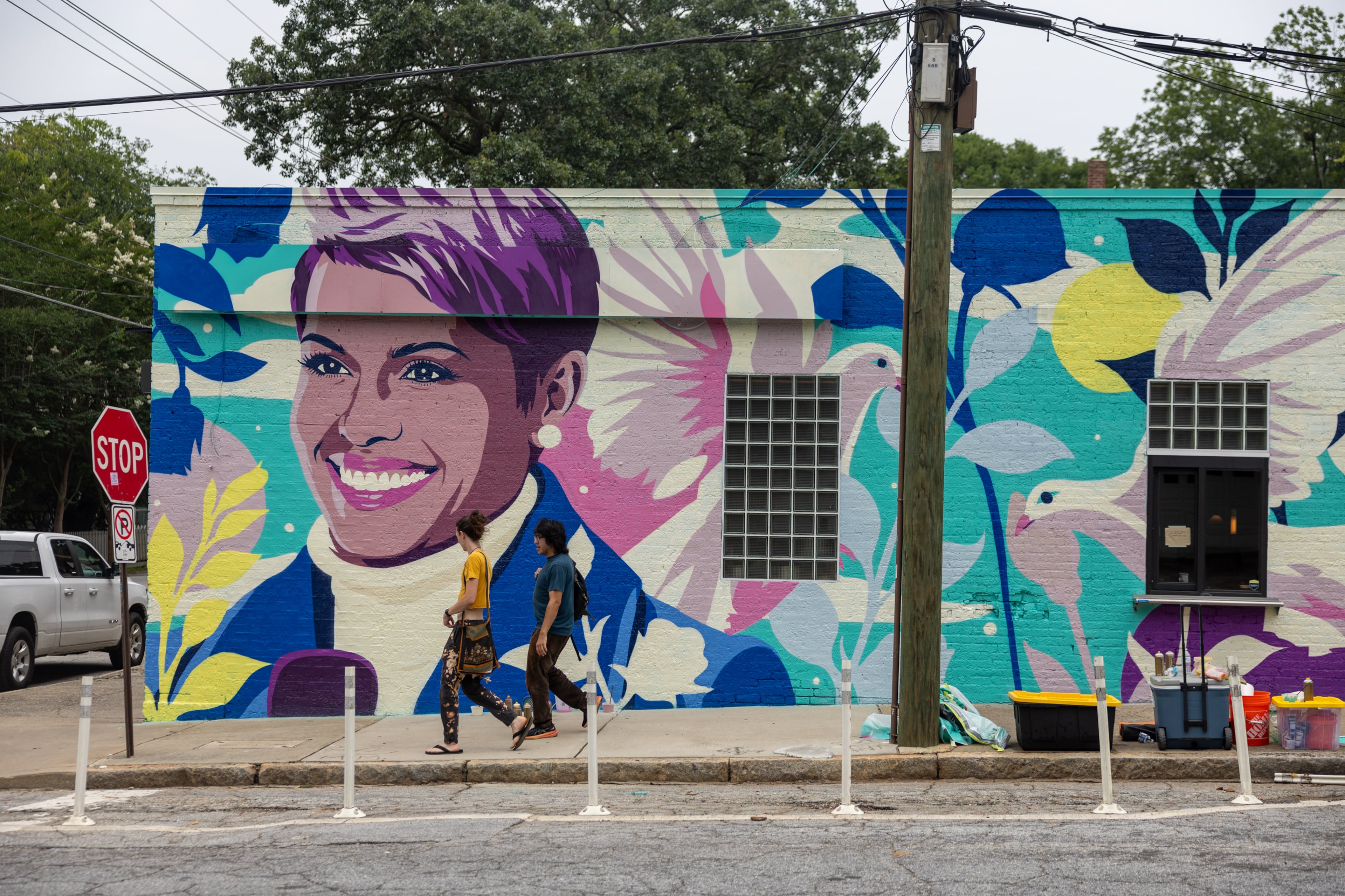 Pedestrians walk past a new mural honoring the late news anchor Jovita Moore on the side of Bellwood Coffee in Atlanta on July 29, 2026. The coffee shop created community outcry when it painted over the original mural of Moore. (Arvin Temkar/AJC)