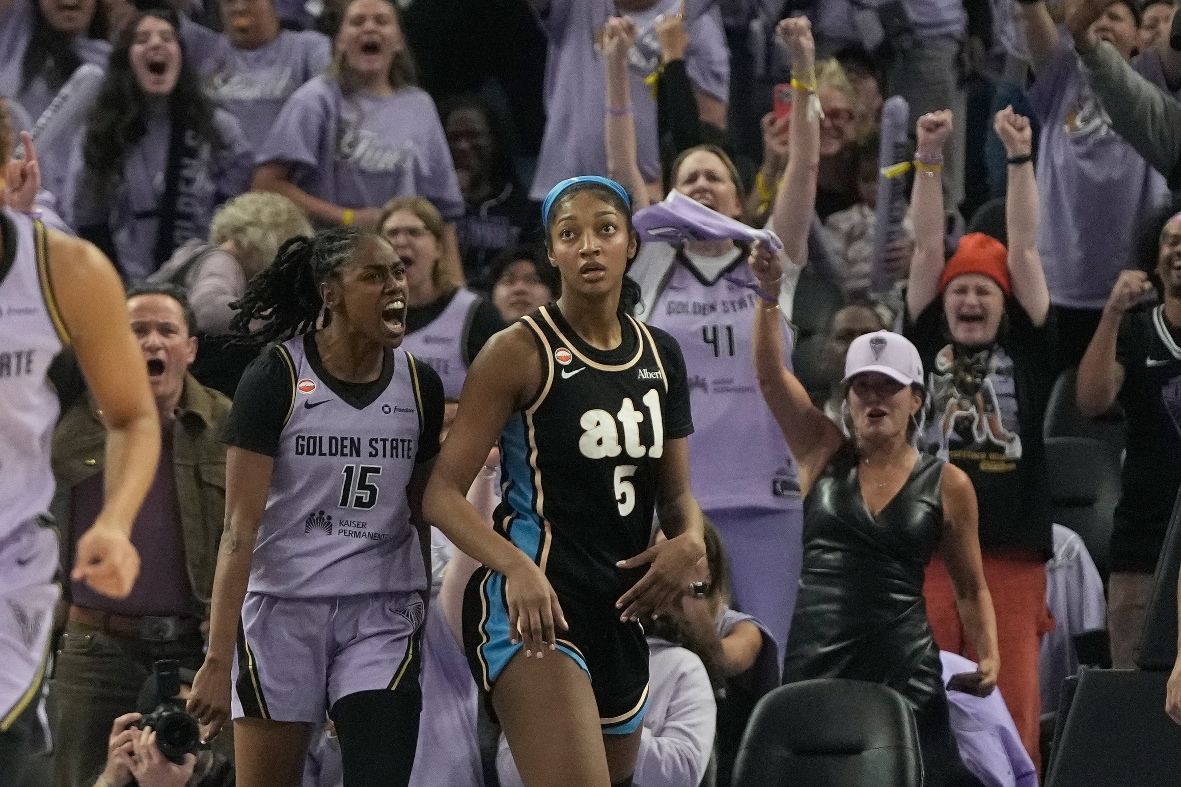 Golden State Valkyries guard Tiffany Hayes (15) celebrates after scoring next to Atlanta Dream forward Angel Reese (5) during the second half of Game 5 of the WNBA basketball finals, Monday, Oct. 26, 2026, in San Francisco. (AP Photo/Jeff Chiu)