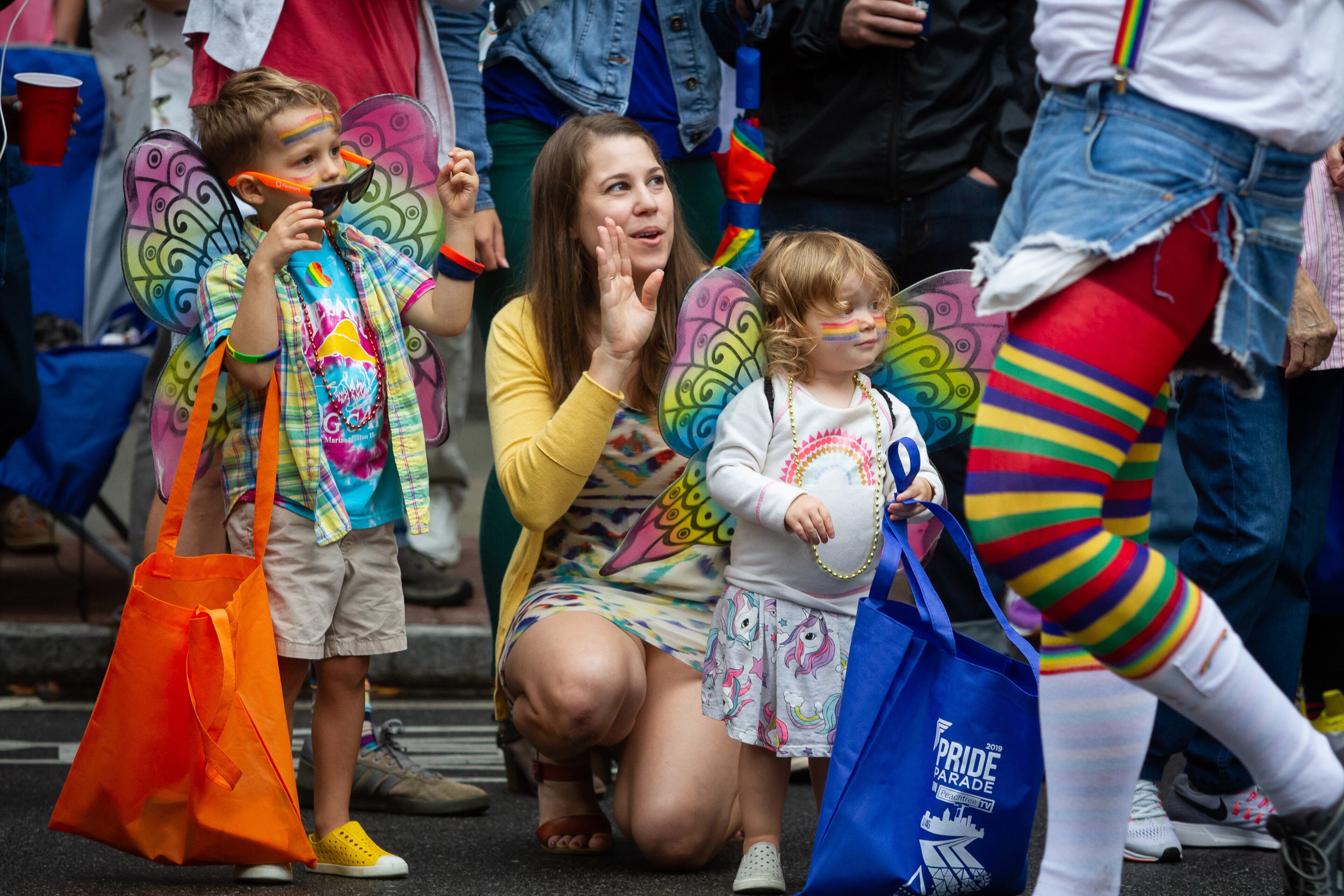 Whitney Panetta, with her two children Cooper(L) and Kennedy (R) cheer on the parade during the 49th annual Pride Festival and Parade in Atlanta on Sunday, Oct. 13, 2019. STEVE SCHAEFER / SPECIAL TO THE AJC