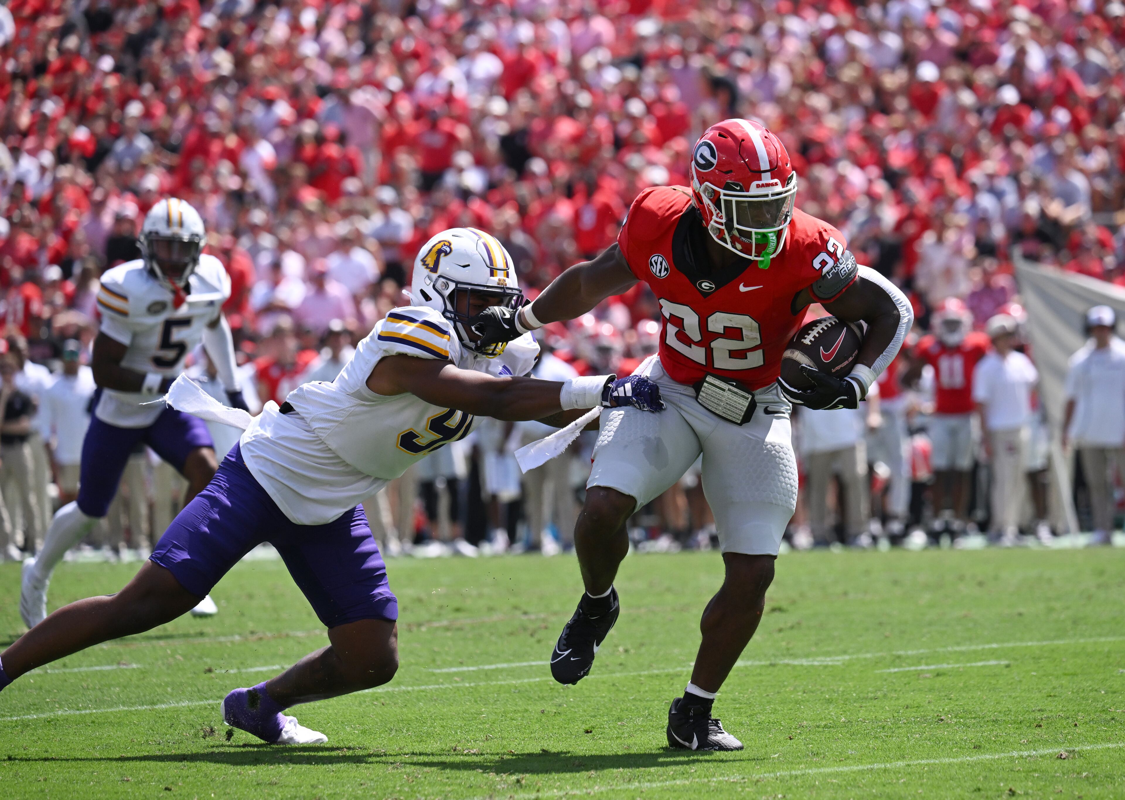 Georgia running back Branson Robinson (22) eludes a tackle by Tennessee Tech defensive lineman Idris King (91) during the first half in an NCAA football game at Sanford Stadium, Saturday, September 9, 2024, in Athens. (Hyosub Shin / AJC)