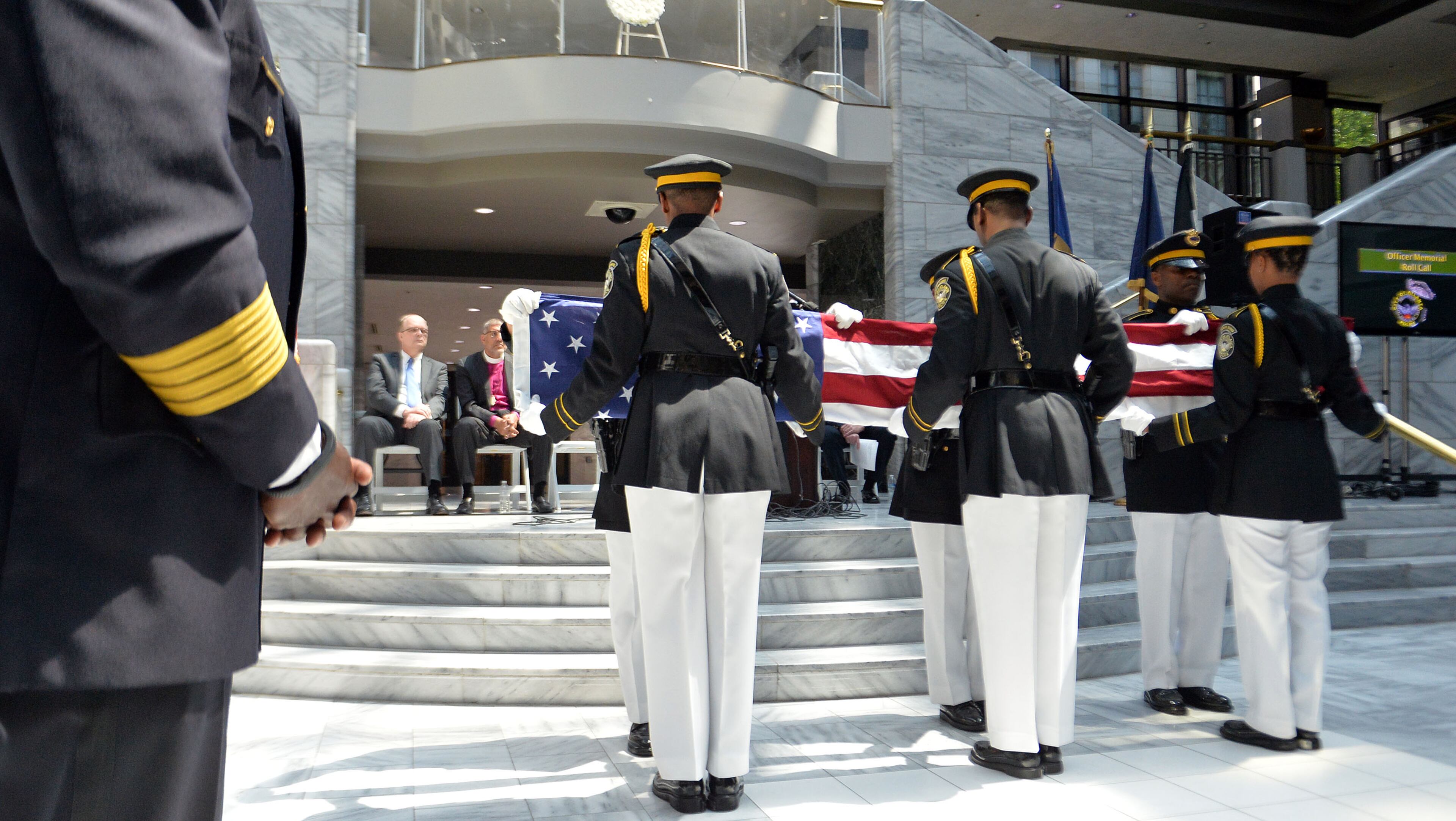 Members of the APD Honor Guard fold the flag during the service. The Atlanta Police Department recognized 82 fallen officers during the 24th Annual Police Memorial Service at the Atlanta City Hall atrium, Tuesday, May 5, 2015. The Right Rev. Robert C. Wright of the Episcopal Diocese of Atlanta was the keynote speaker. Additional speakers included Atlanta Police Chief George N. Turner, Michael Geisler, Chief Operating Officer, City Council President Ceasar C. Mitchell and Council member C.T. Martin, Public Safety Chair. KENT D. JOHNSON /KDJOHNSON@AJC.COM