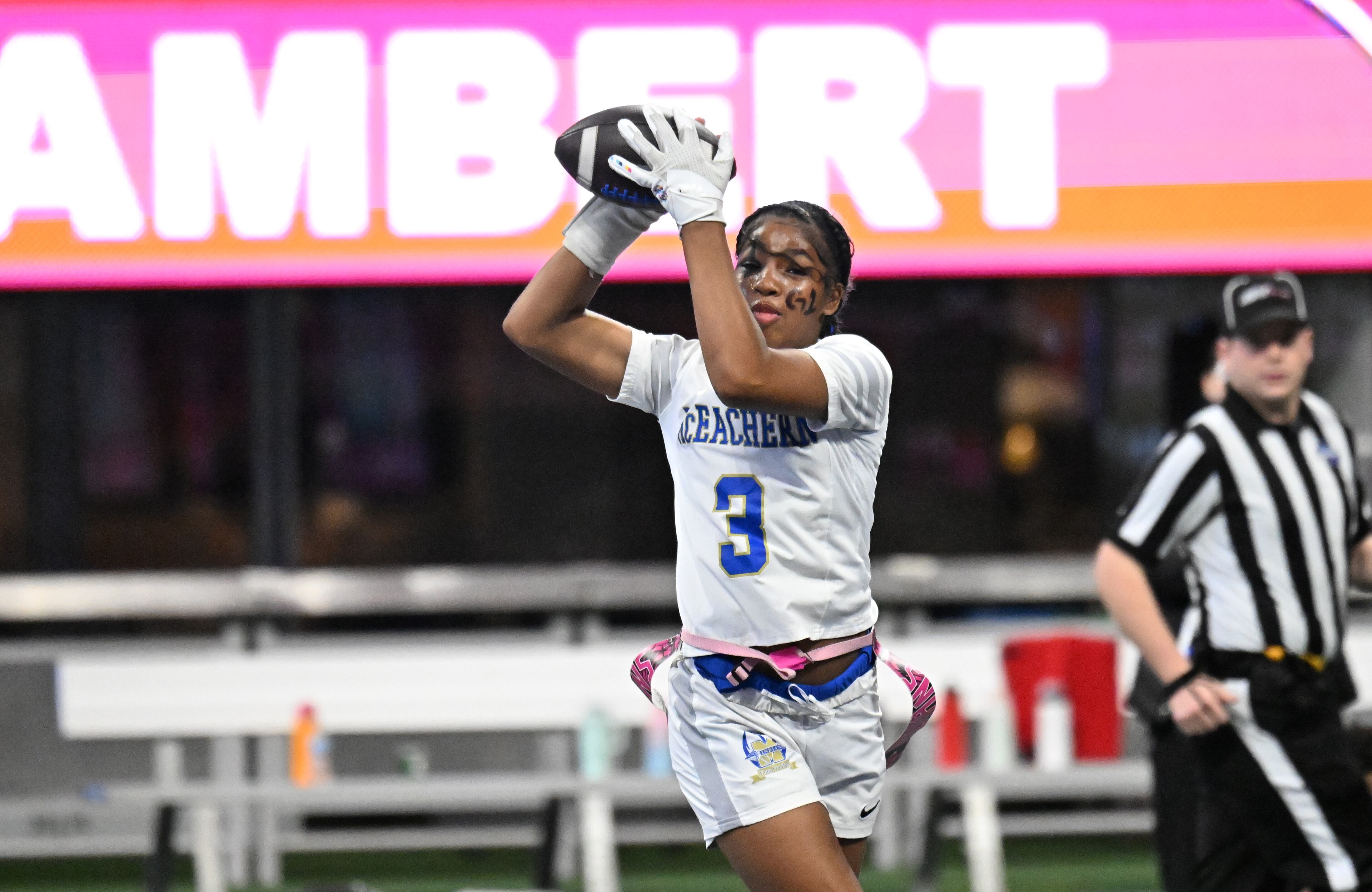 McEachern's Ava Couzens (3) makes a catch during the first half in GHSA Division 4 Flag Football State Championship game at Mercedes-Benz Stadium, Wednesday, December 18, 2024, in Atlanta. McEachern won 26-6 over Lambert. (Hyosub Shin / AJC)