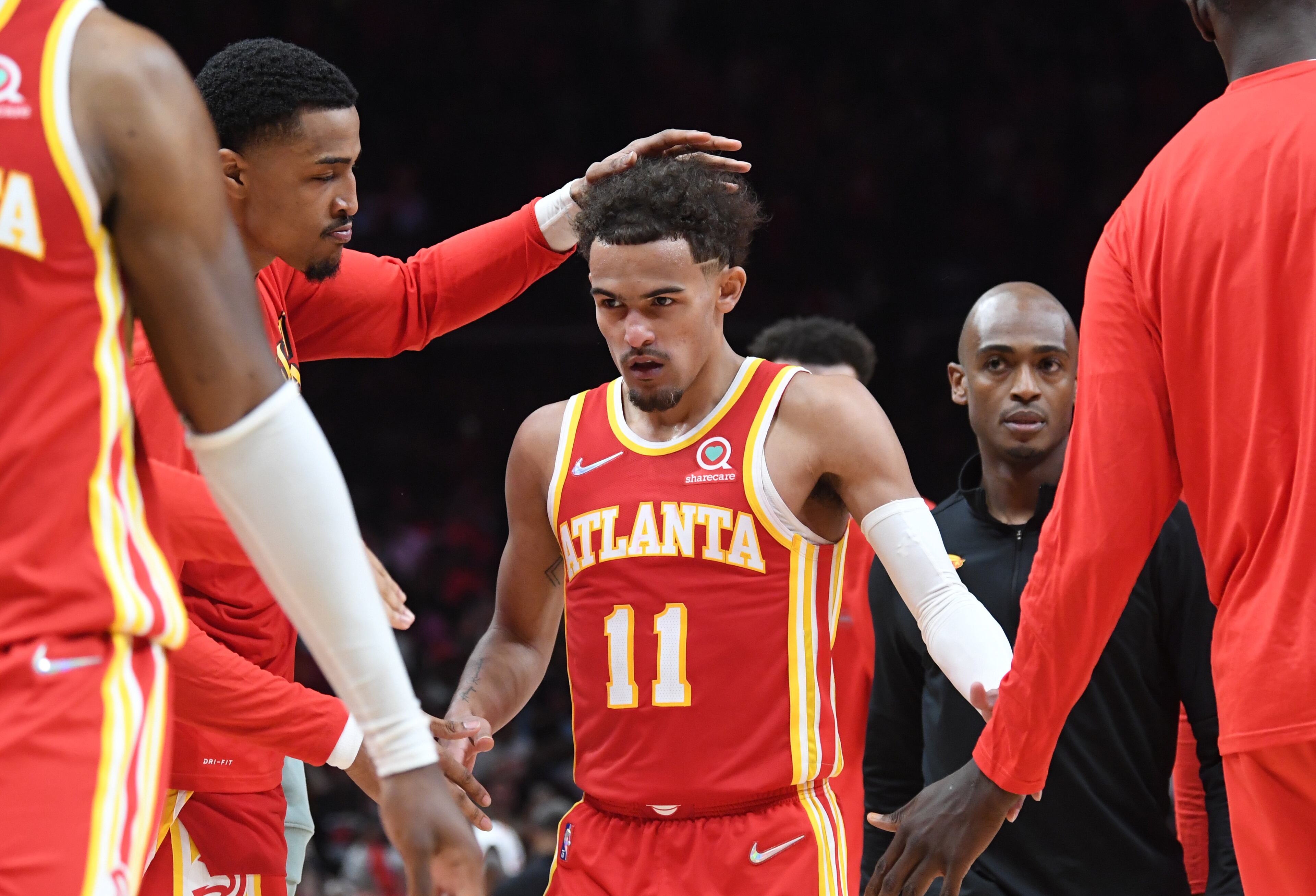 April 22, 2022 Atlanta - Atlanta Hawks' guard Trae Young (11) is congratulated by a teammate after scoring the game winning shot at the end of the 4th quarter in Game 3 of the first round of the NBA playoffs at State Farm Arena on Friday, April 22, 2022. Atlanta Hawks won 111-110 over Miami Heat. (Hyosub Shin / Hyosub.Shin@ajc.com)