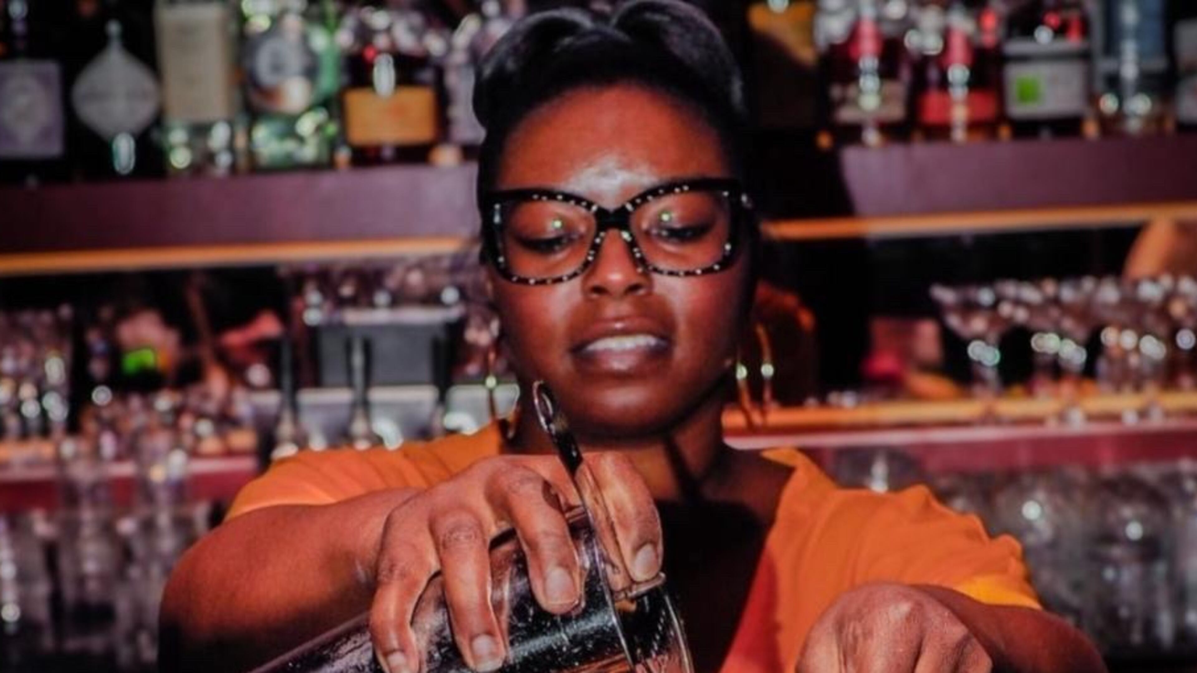 Kia Palmer shaking up cocktails using Black owned spirits at Jo Jo's beloved Cocktail Lounge. /
Courtesy of Nate Refell