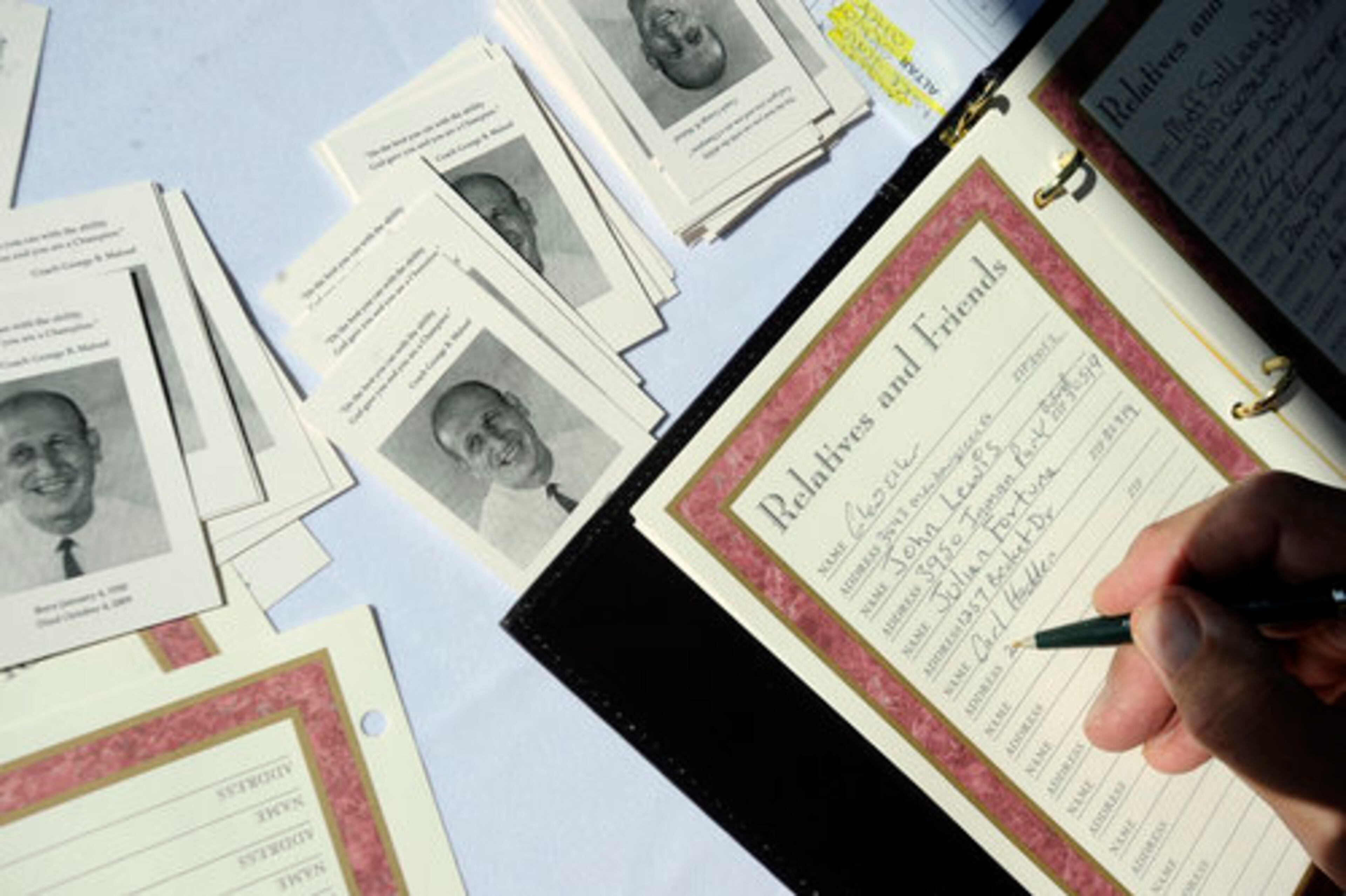 Carl Hadden, of Duluth, signs in a guestbook. Hadden was a student of George Maloof in 1957 at Smith High School in Atlanta.