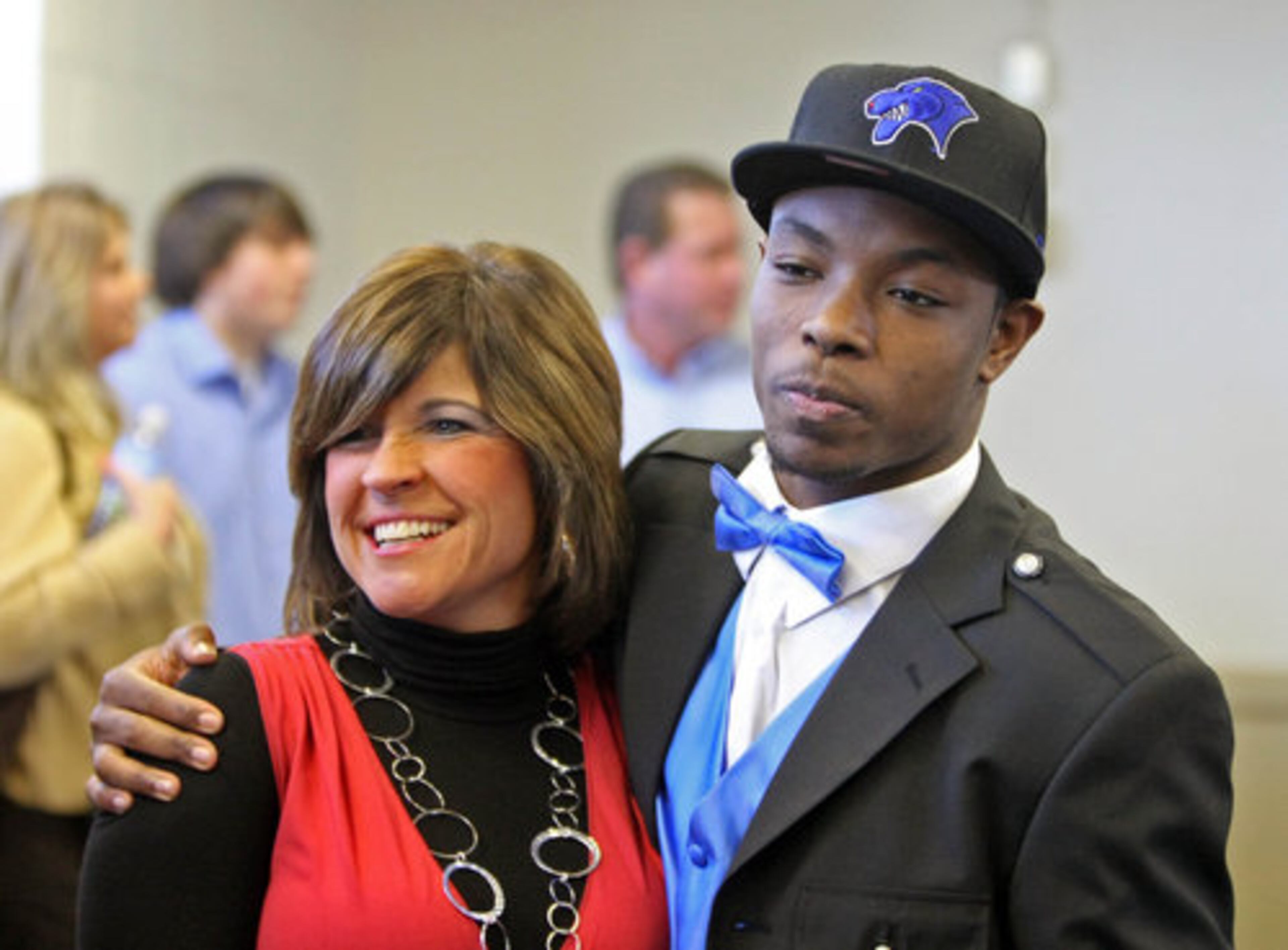 Newnan High School science teacher Amy Benton, left, gets a hug from student and GSU signee Jamal Ransby (10) after Ransby signed on National Signing Day Wednesday morning in Newnan, Ga., February 3, 2010. Ransby is a defensive back with Newnan.