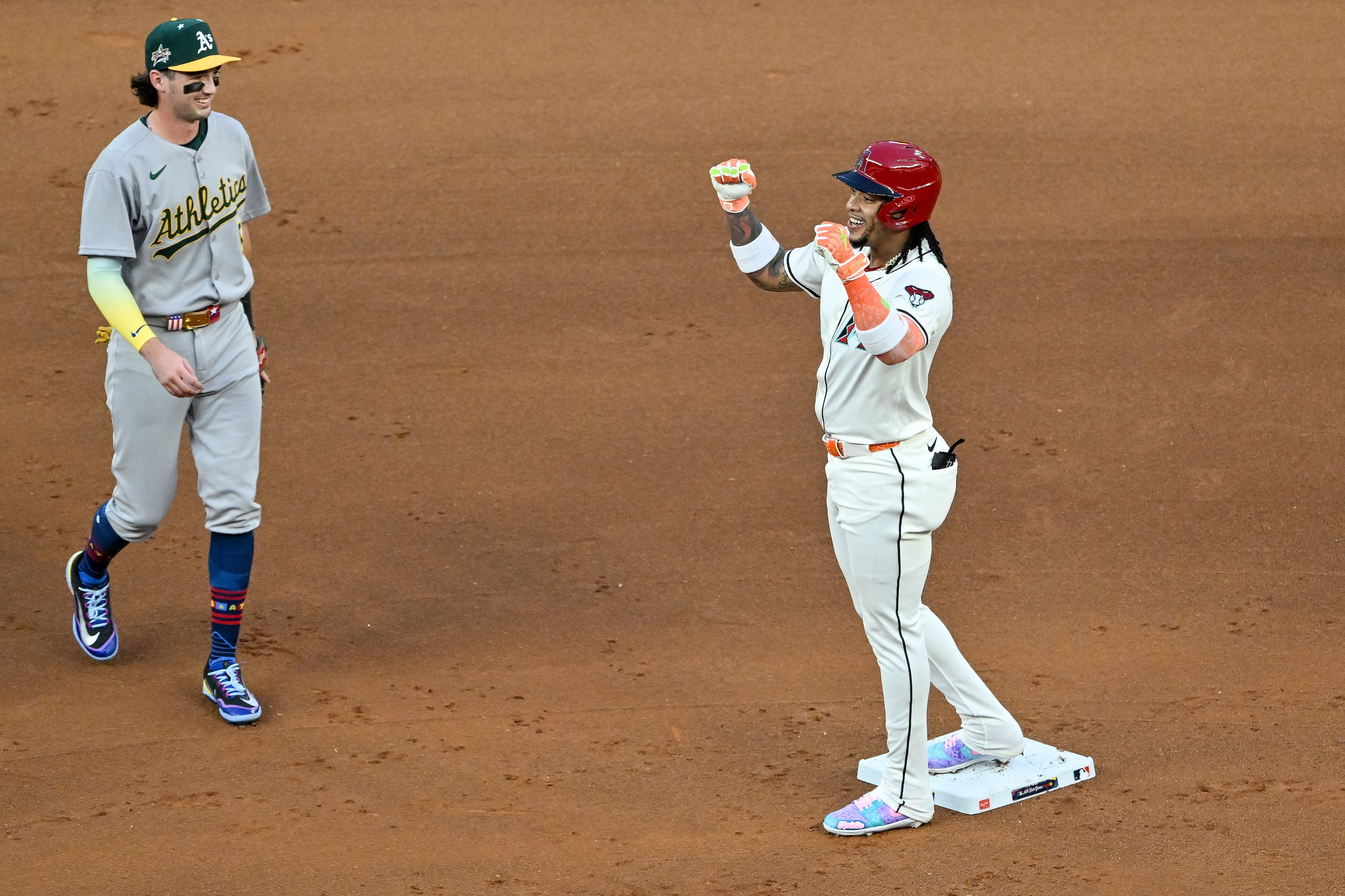 The National League's Ketel Marte of the Arizona Diamondbacks celebrates a two-RBI double against the American League during the first inning of the MLB All-Star Game at Truist Park in Atlanta on Tuesday, July 15, 2025. (Hyosub Shin/AJC)