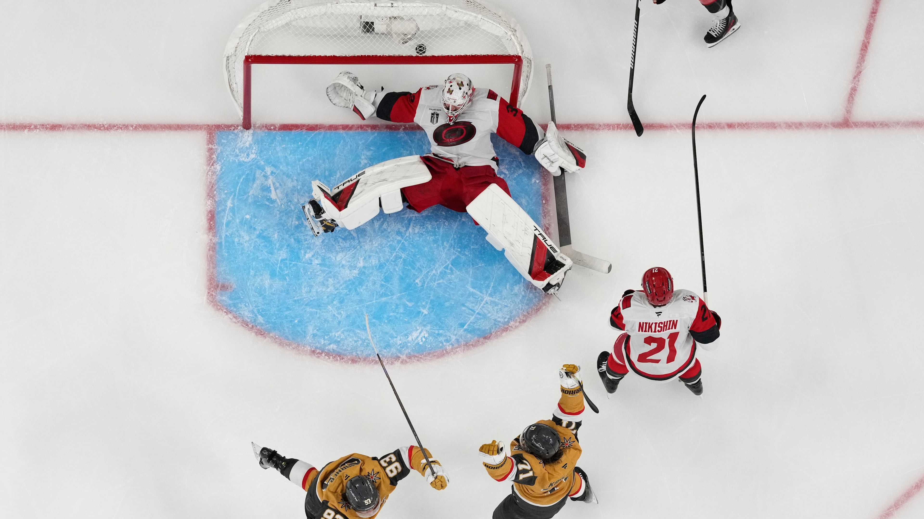 Vegas Golden Knights center William Karlsson (71) and Vegas Golden Knights right wing Mitch Marner (93) celebrate after Vegas Golden Knights defenseman Shea Theodore scored against Carolina Hurricanes goaltender Brandon Bussi (32) during the second overtime in Game 3 of the NHL hockey Stanley Cup Final series, Saturday, June 6, 2026, in Las Vegas. (AP Photo/John Locher)