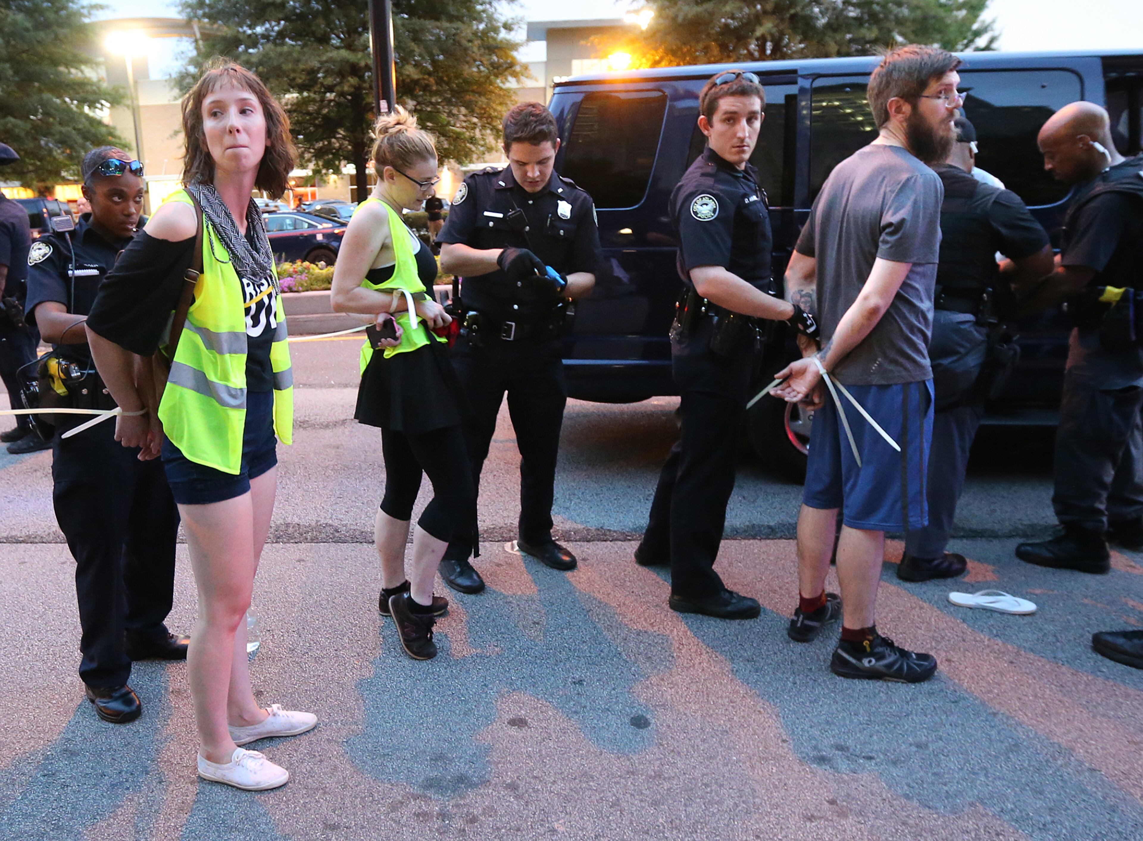 Three protesters are among several arrested on Peachtree Road during a march from the Lenox MARTA station to the Governor's mansion during a fifth night of demonstrations on Monday, July 11, 2016, in Atlanta. Curtis Compton /ccompton@ajc.com
