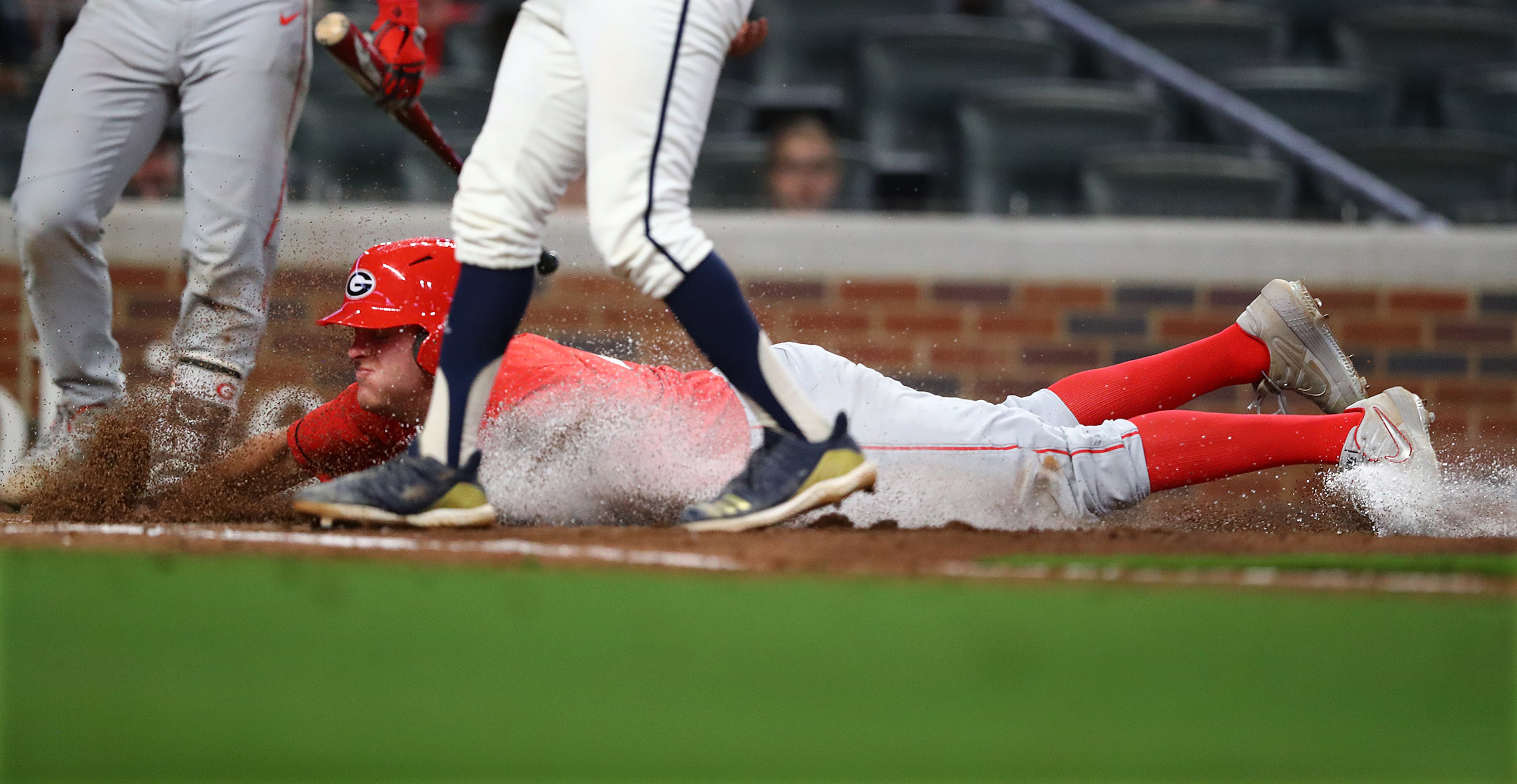 April 23, 2019 Atlanta: Georgia infielder L.J. Talley scores from third on a wild pitch by Georgia Tech during the fourth inning in the Spring Classic NCAA college baseball game at SunTrust Park on Tuesday, April 23, 2019, in Atlanta. Curtis Compton/ccompton@ajc.com