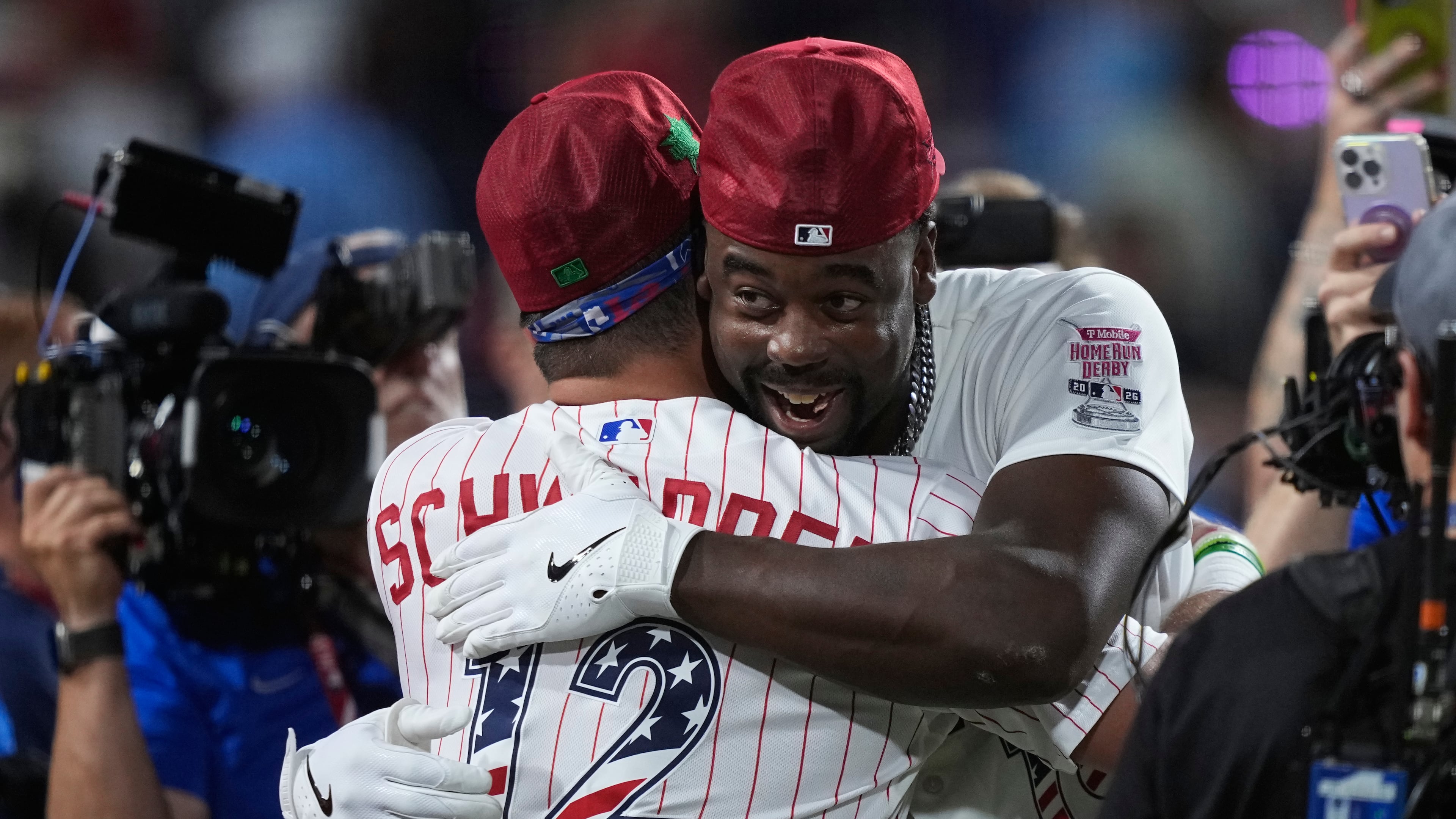 St. Louis Cardinals' Jordan Walker embraces Philadelphia Phillies' Kyle Schwarber after Walker won the MLB baseball All-Star Home Run Derby, Monday, July 13, 2026, in Philadelphia. (AP Photo/Matt Slocum)